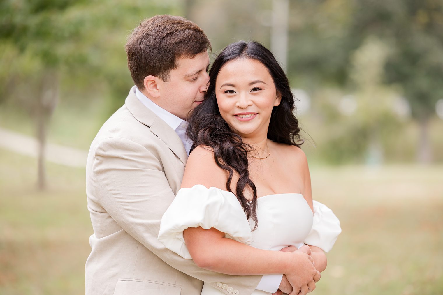 fiancé putting his head in his bride hair