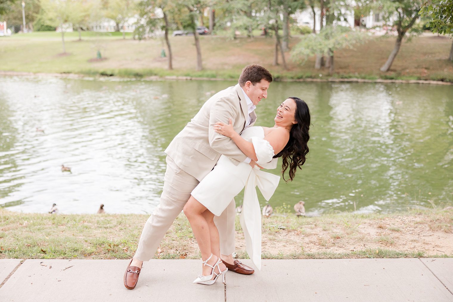 fiancé holding his bride at spring lake 