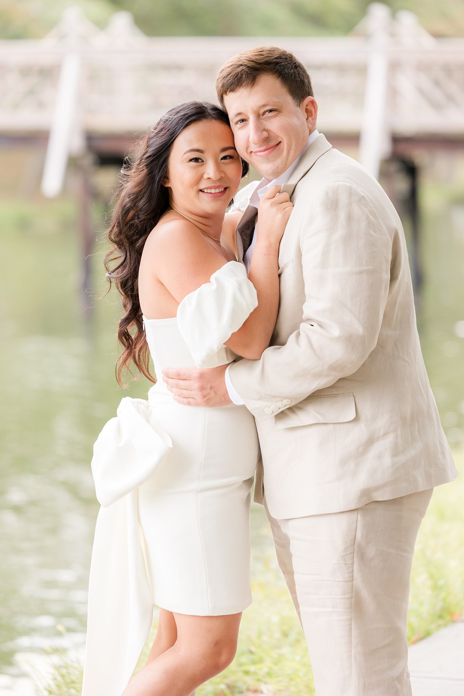 bride and fiancé hugging and looking to the camera 