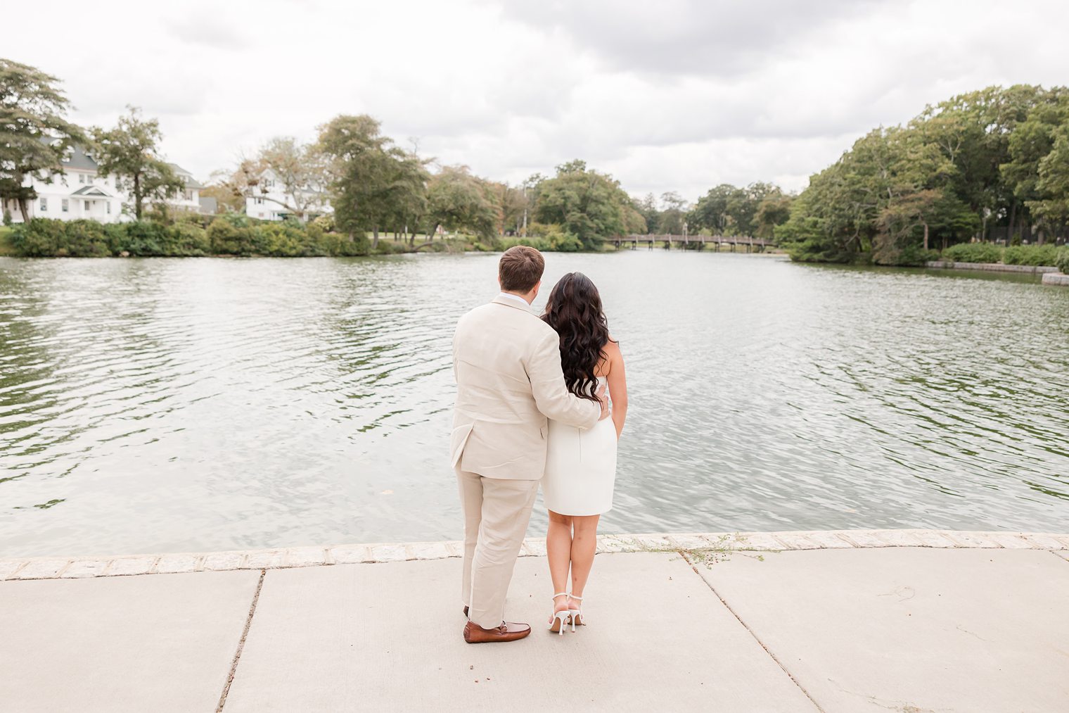 bride and fiancé admiring the beauty of the spring lake 