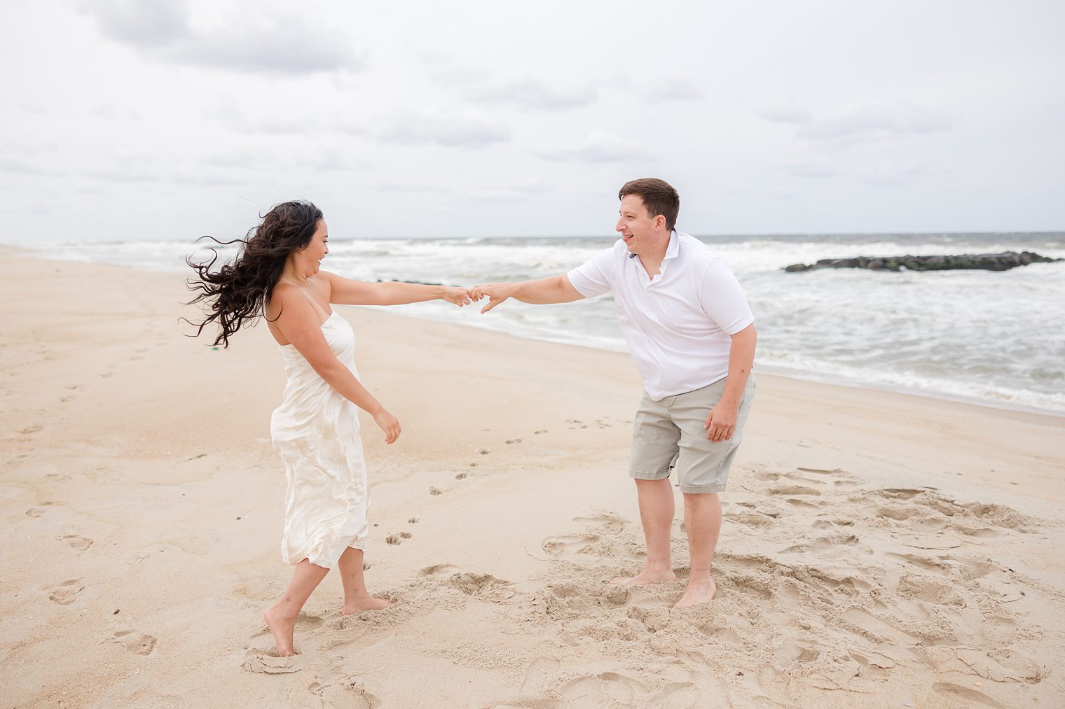 Happy couple dancing at the beach 