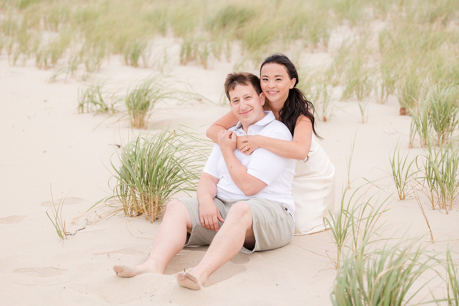 happy enjoying a moment at the beach during their engagement session