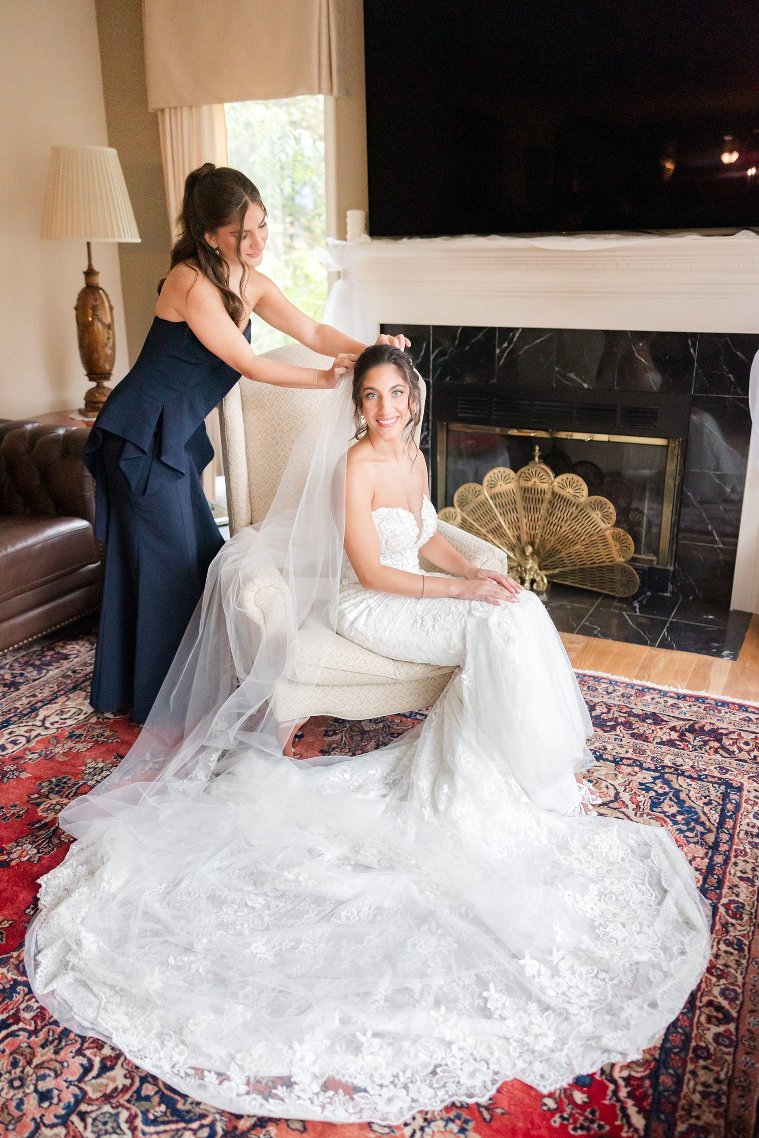 Bridesmaid helping bride with final touches 