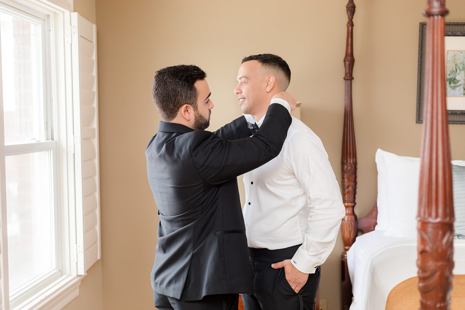 Best man helping the groom with final touches 