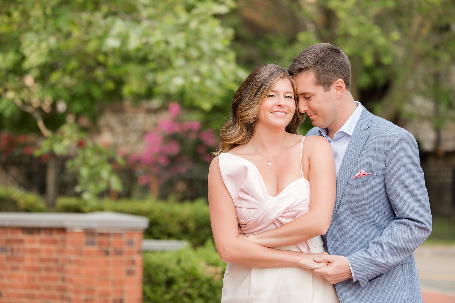 bride looking to the camara while her fiancé is putting his face on her chic