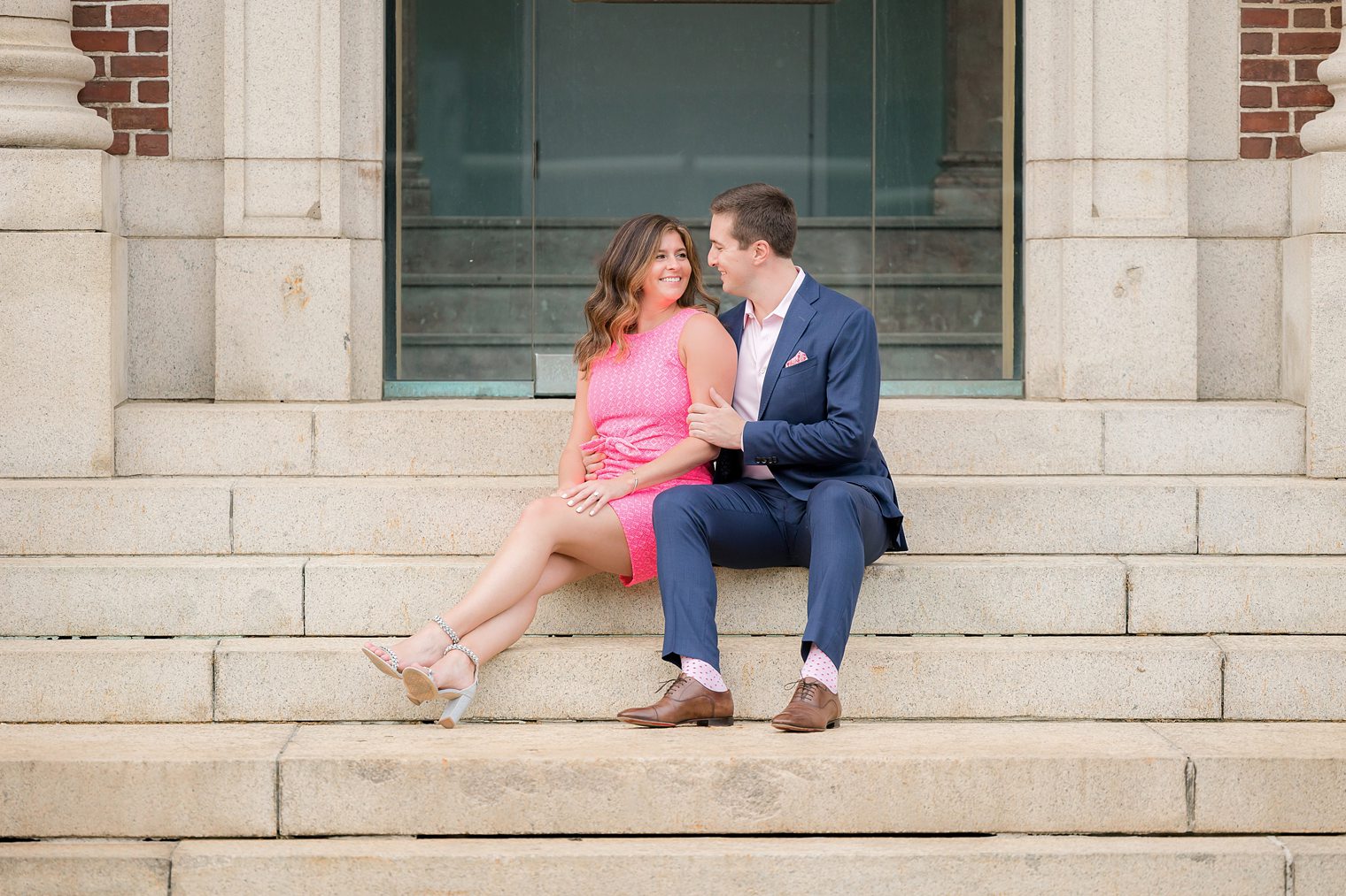 future husband and wife sitting in the stairs looking each other 