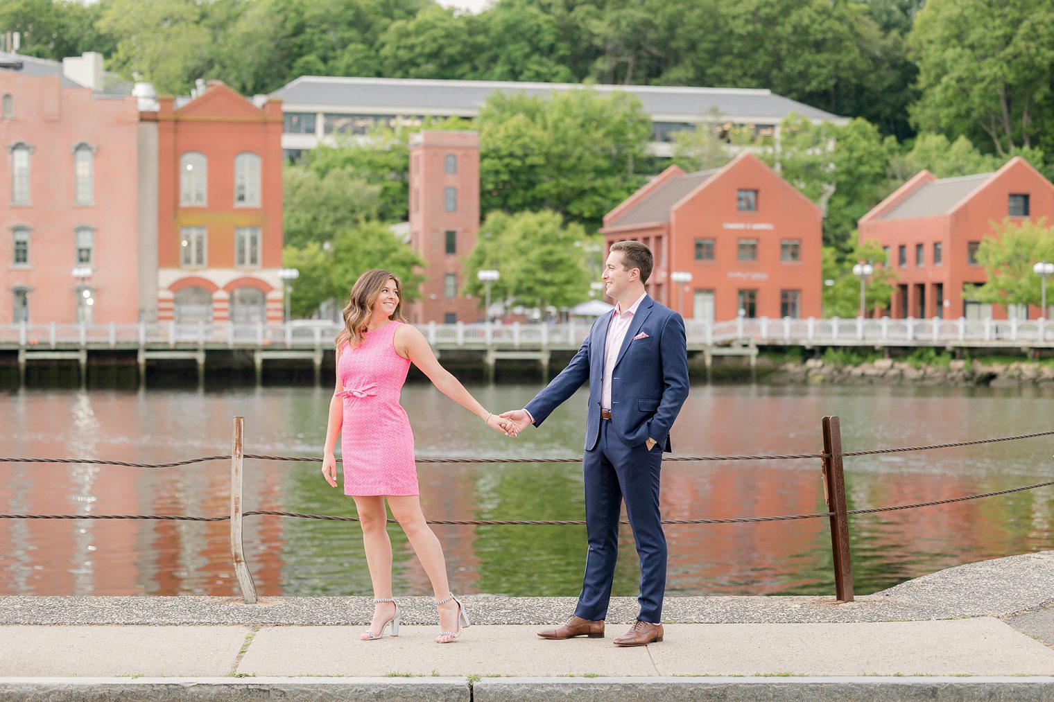 future husband and wife holding hands while looking each other 