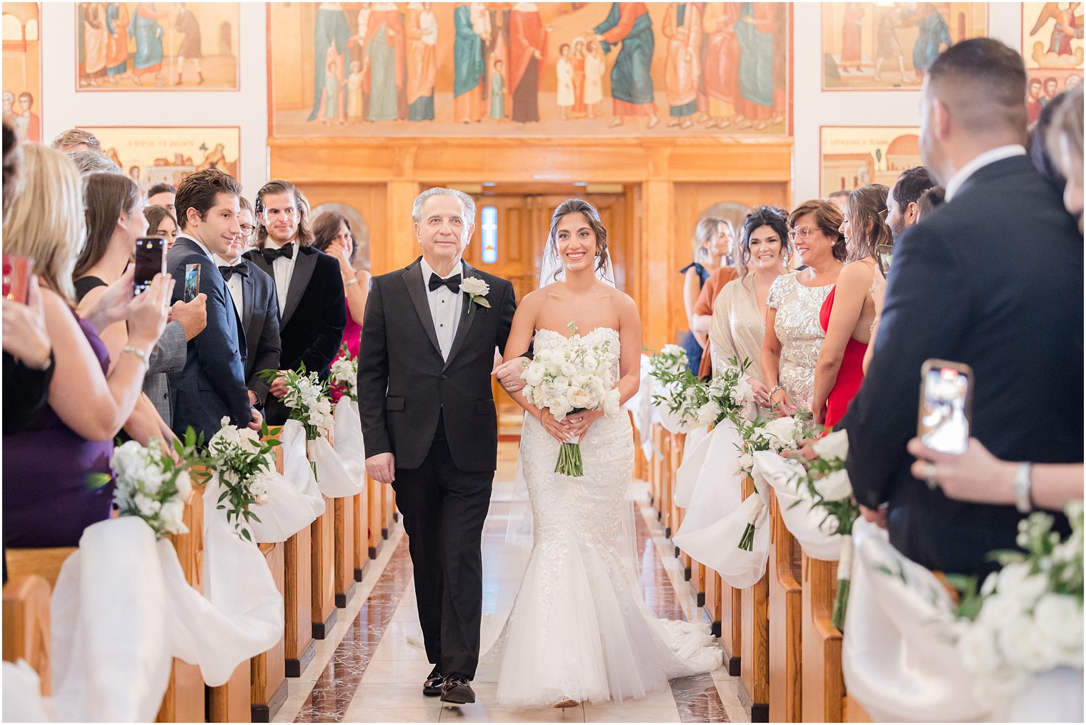 The bride and her father walking down the aisle 