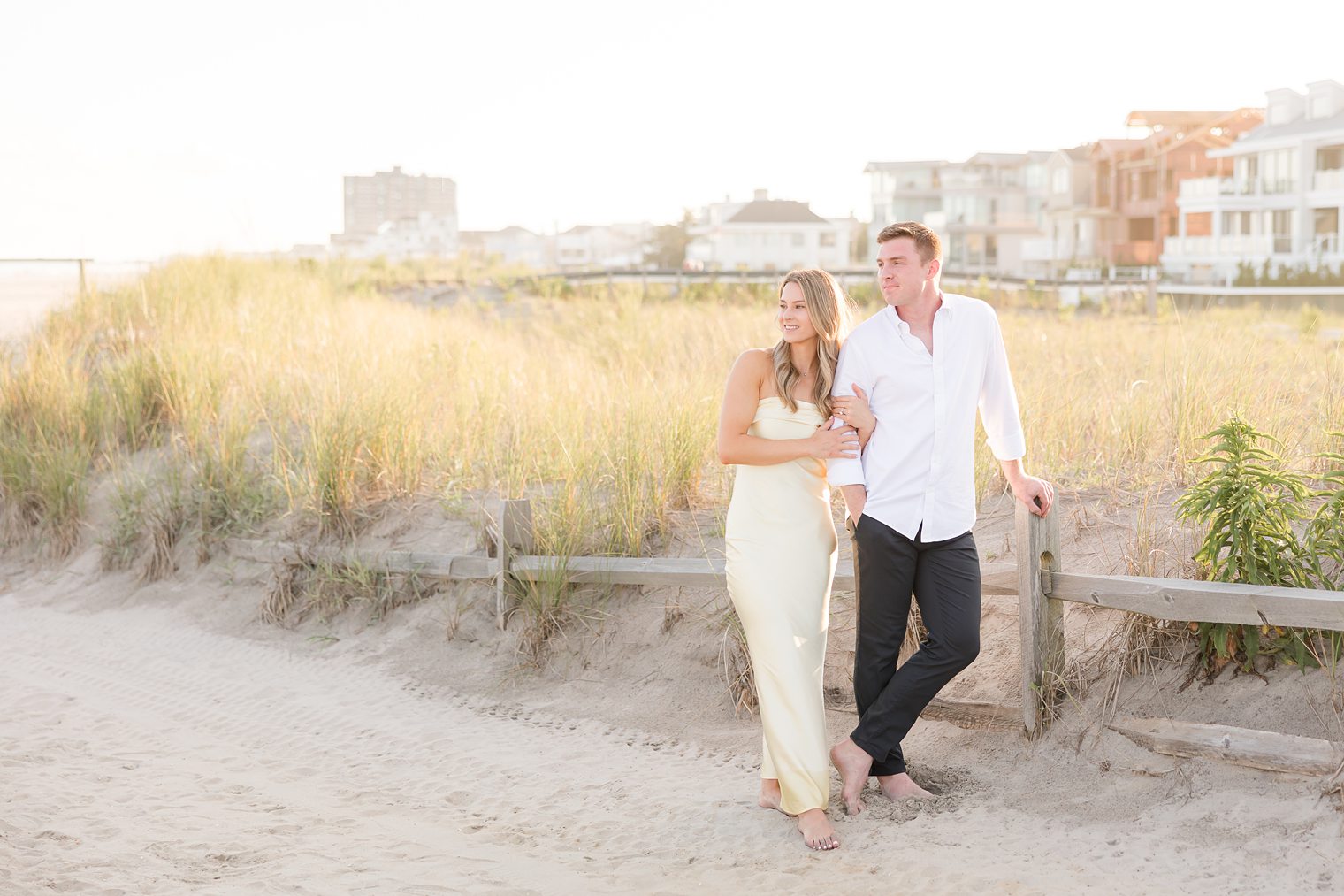 fiancé and his bride looking at the sunset