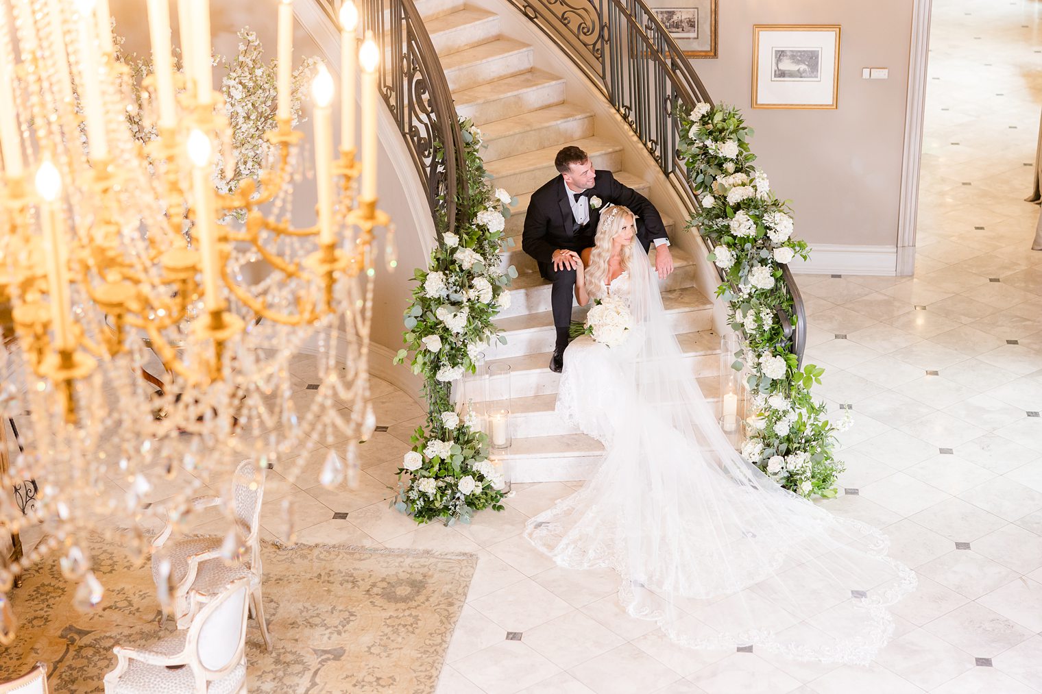 bride and groom sitting on the stairs at Park Chateau Estate