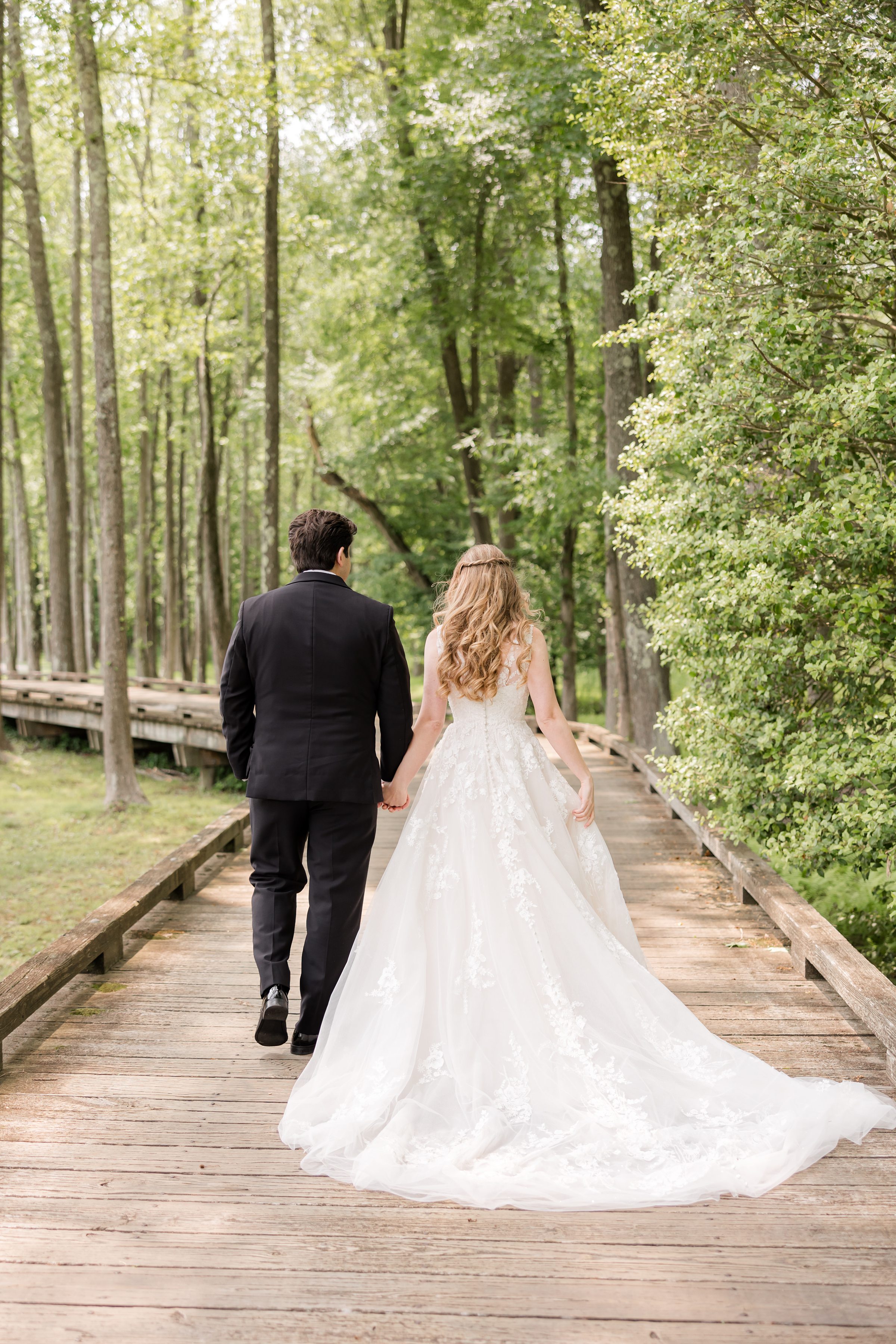 Bride and groom walking in the forest