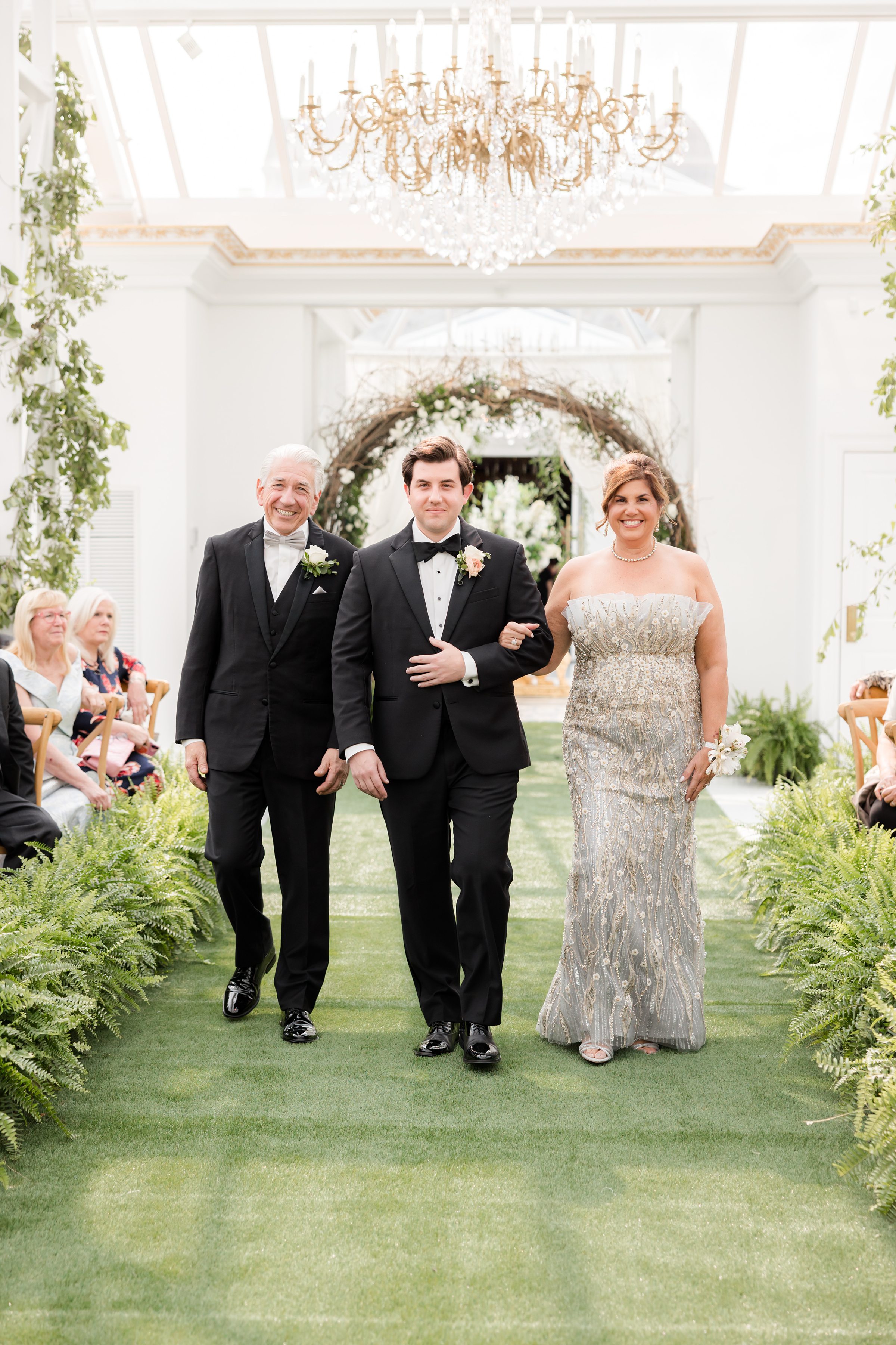 Parents of the groom walking him down the aisle