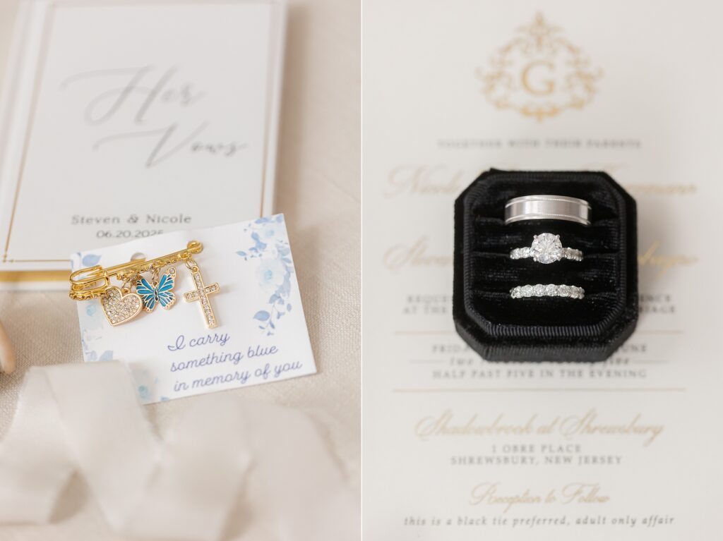 heirloom pin and wedding bands on a vow book and wedding invitation