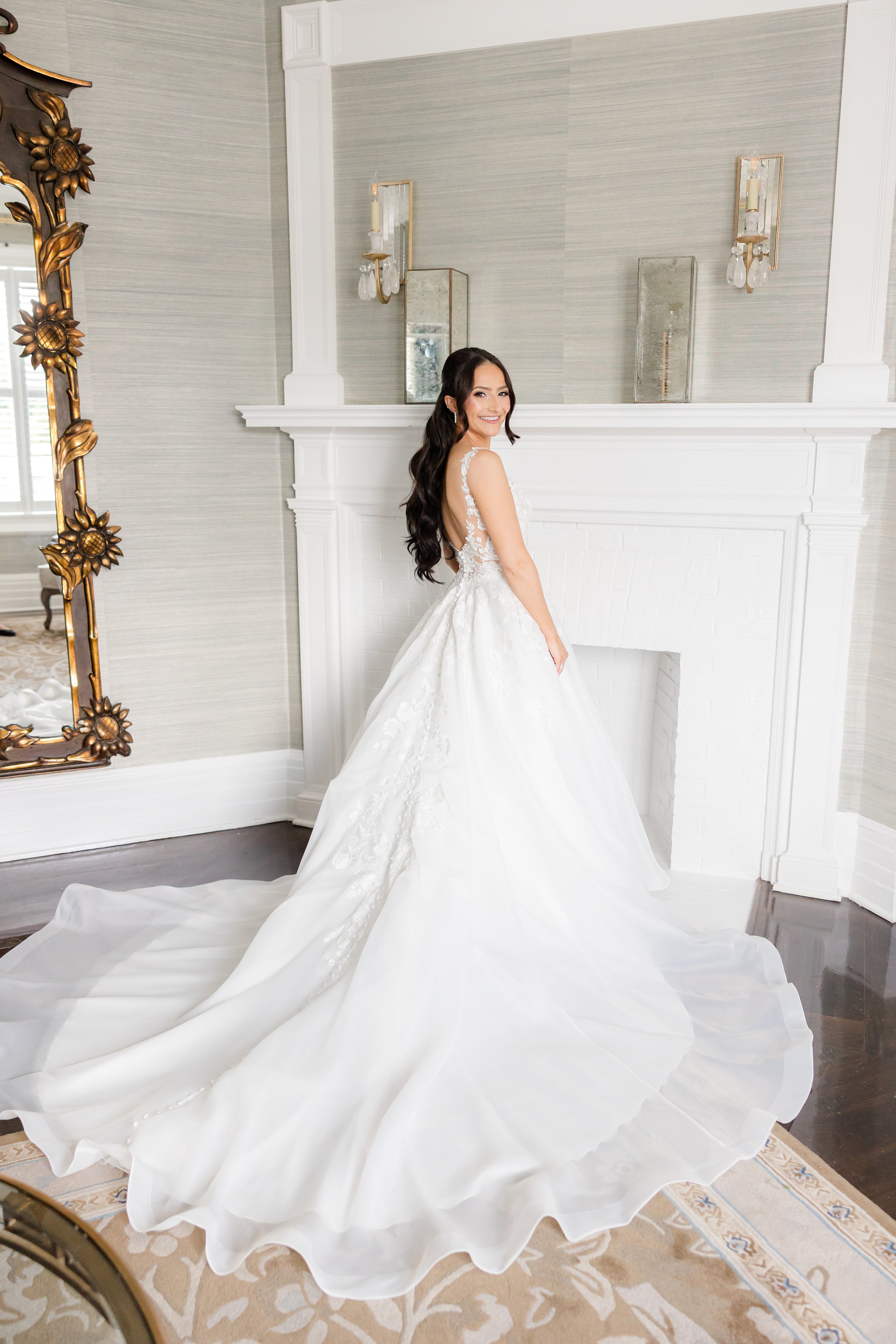 Bride is wearing the lace wedding gown showing the back details