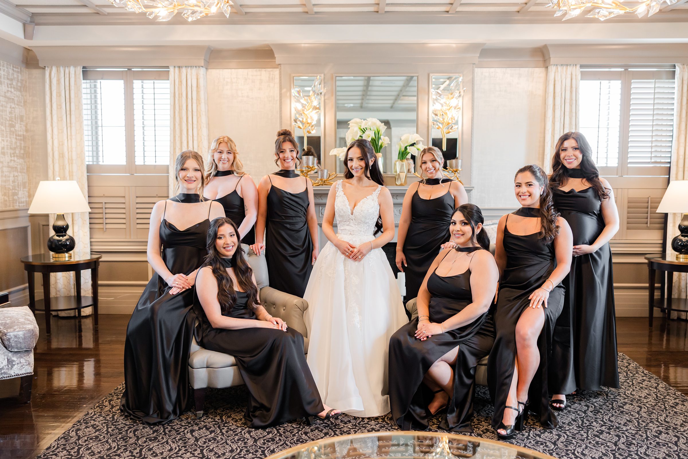 The bride is in the middle of bridesmaids posing together