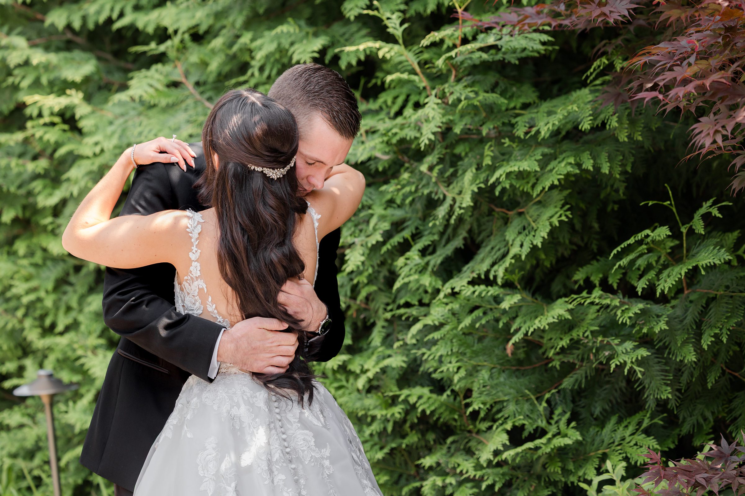 Bride and groom hugging each other after getting ready 