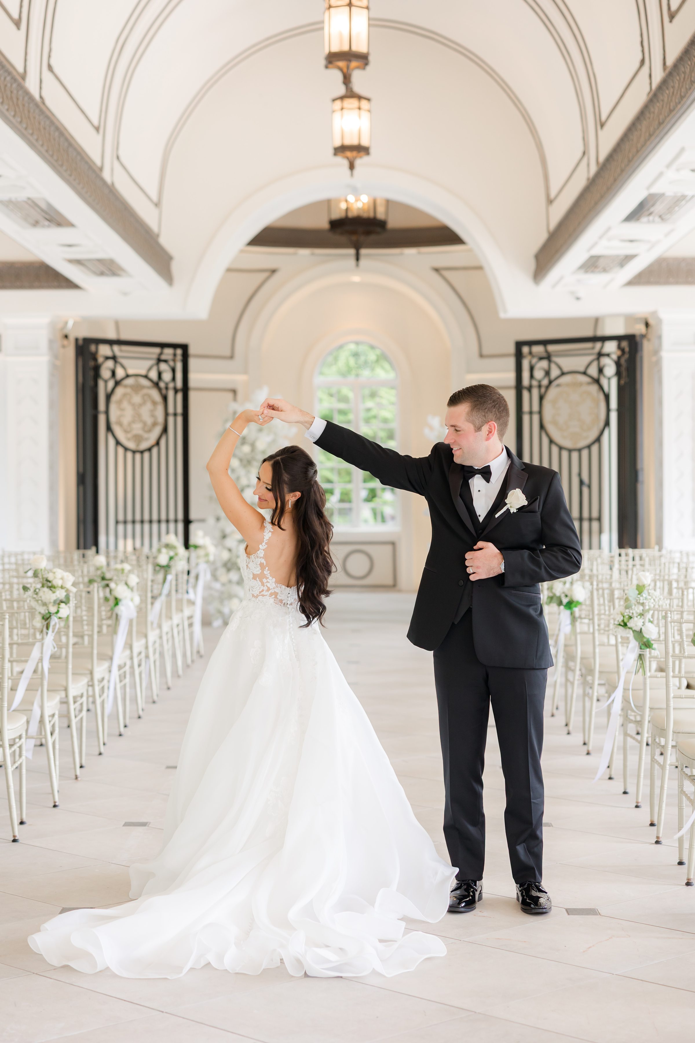 Bride and groom posing in the reception hall