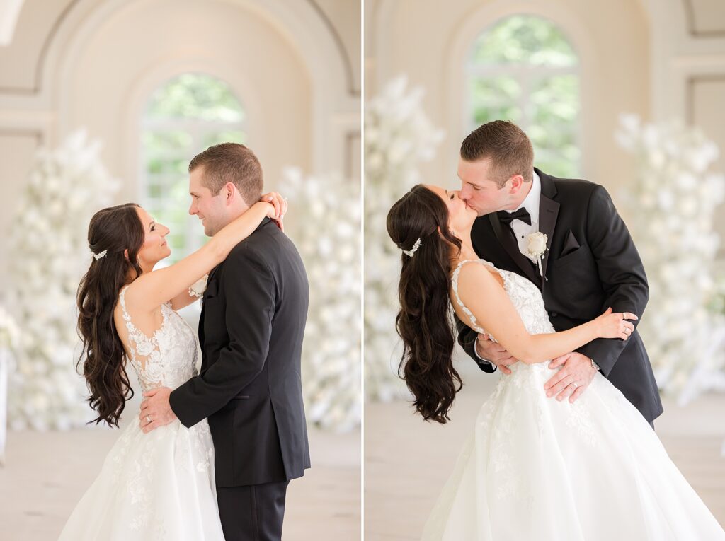 Bride is wrapping her arms around the groom and kissing each other in the reception hall
