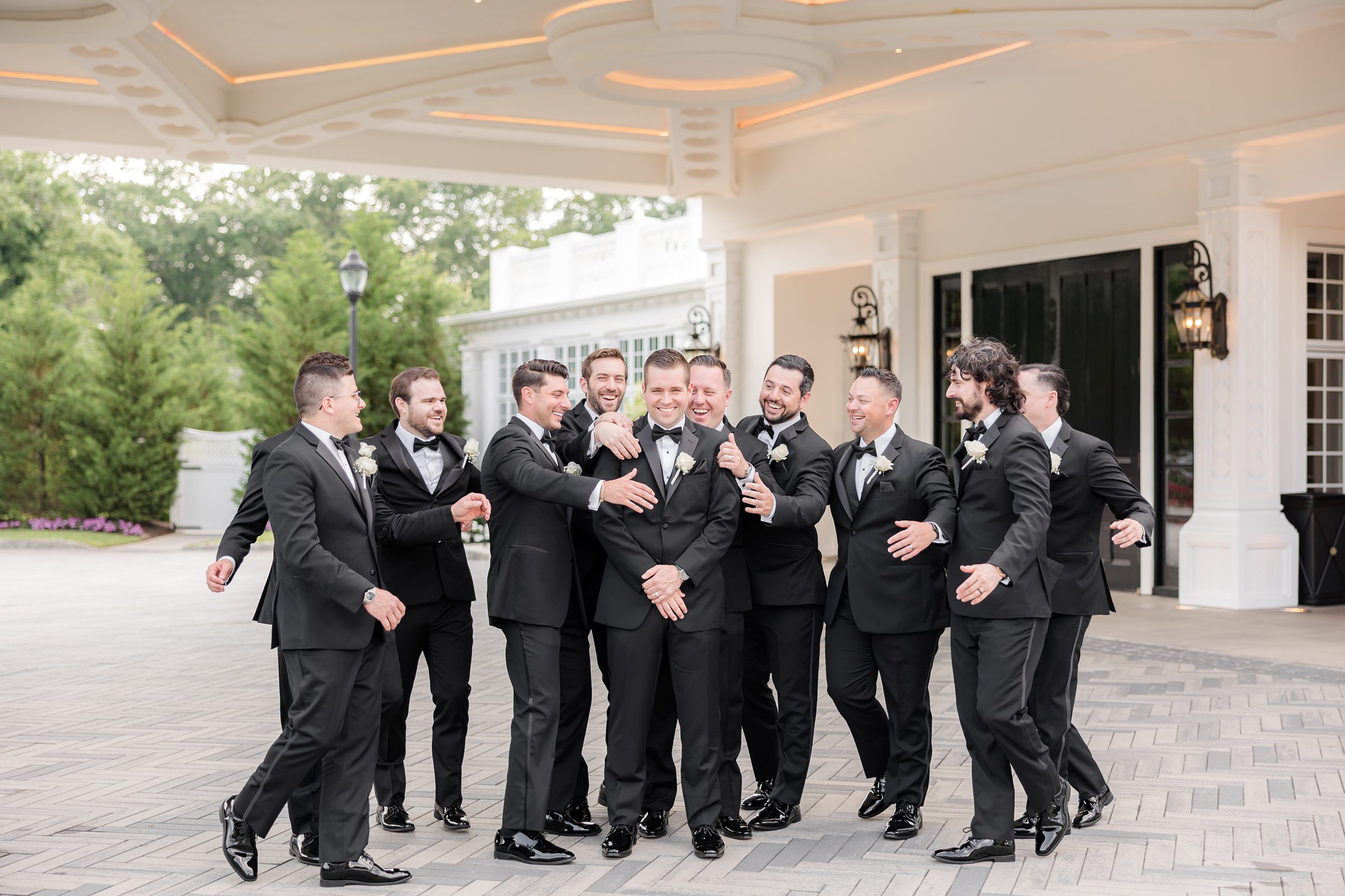 The groom is laughing with groomsmen at Shadowbrook 