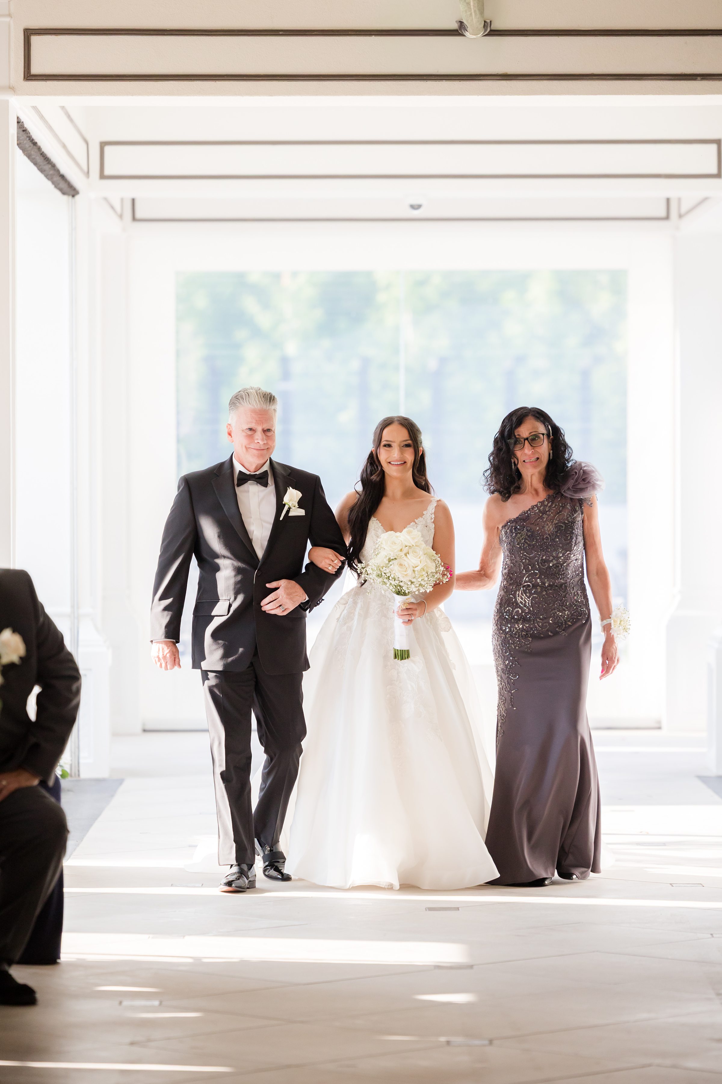 Parents of bride walking her down the aisle 