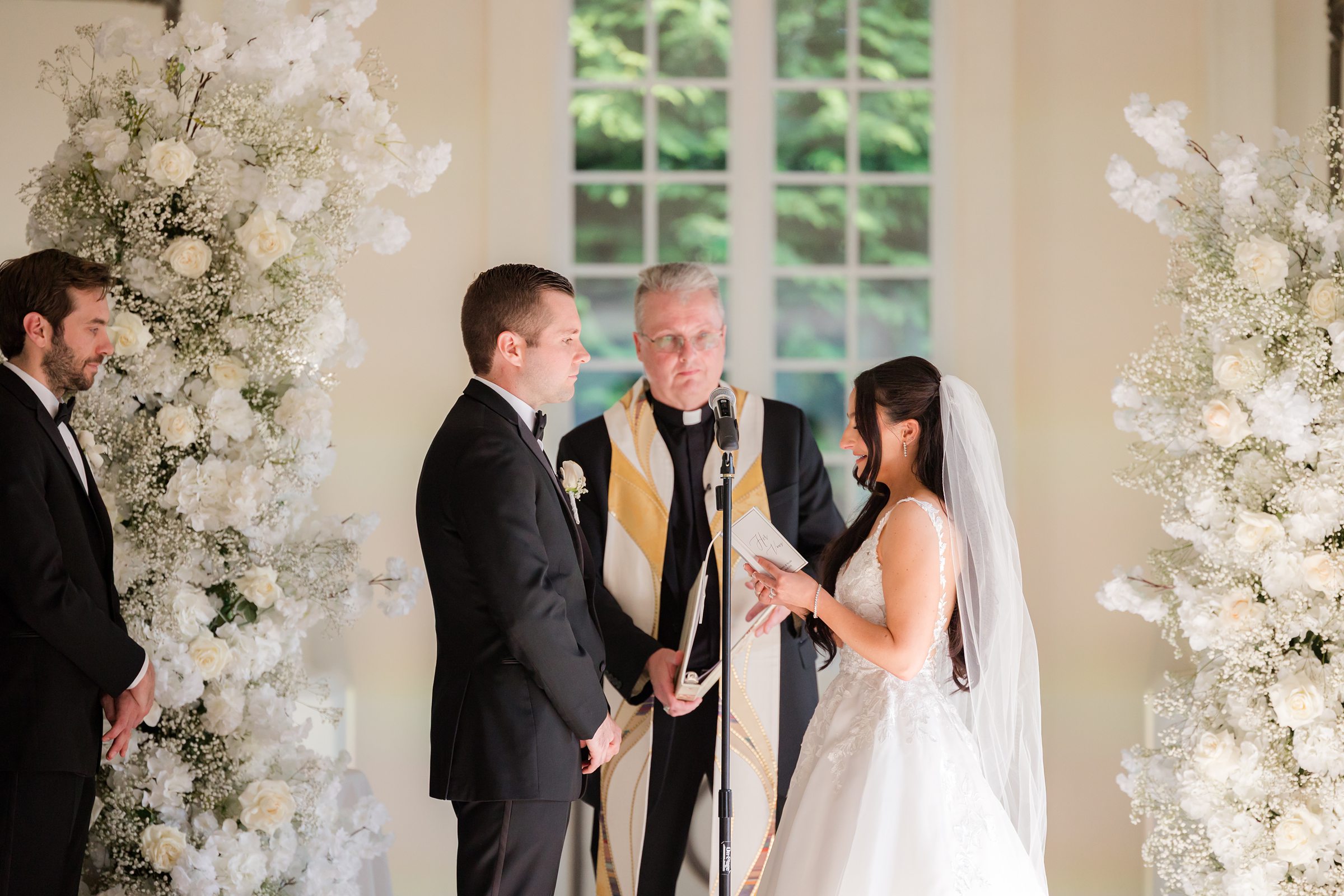 Bride is reading her vow notes to his groom at the altar 
