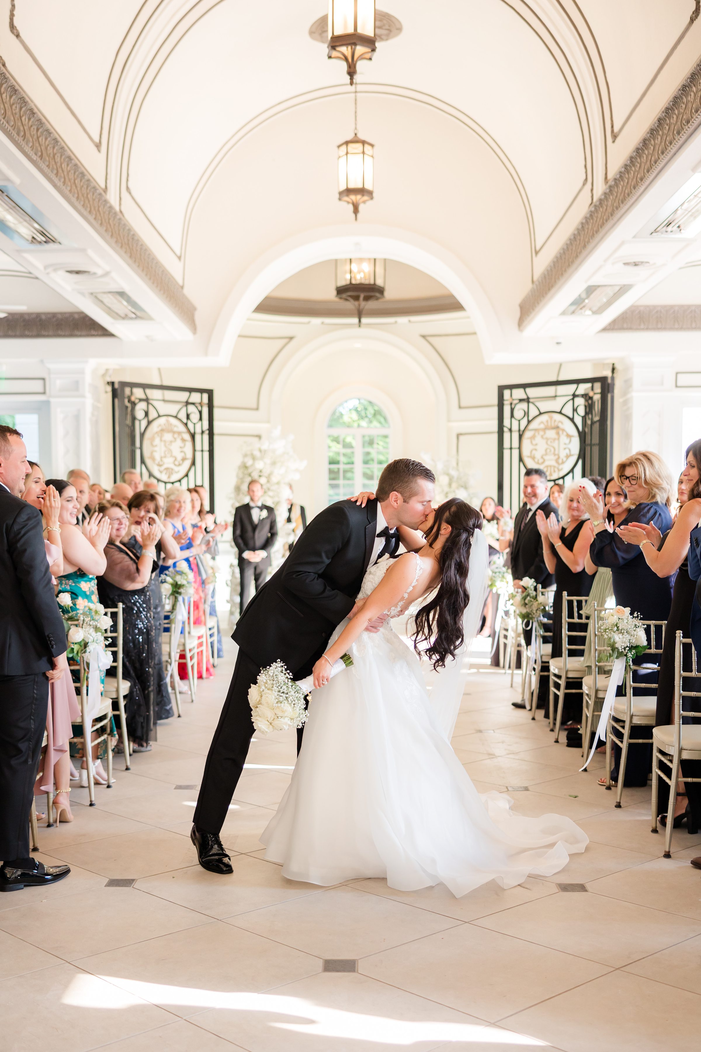 Bride and groom are kissing each other at the altar 