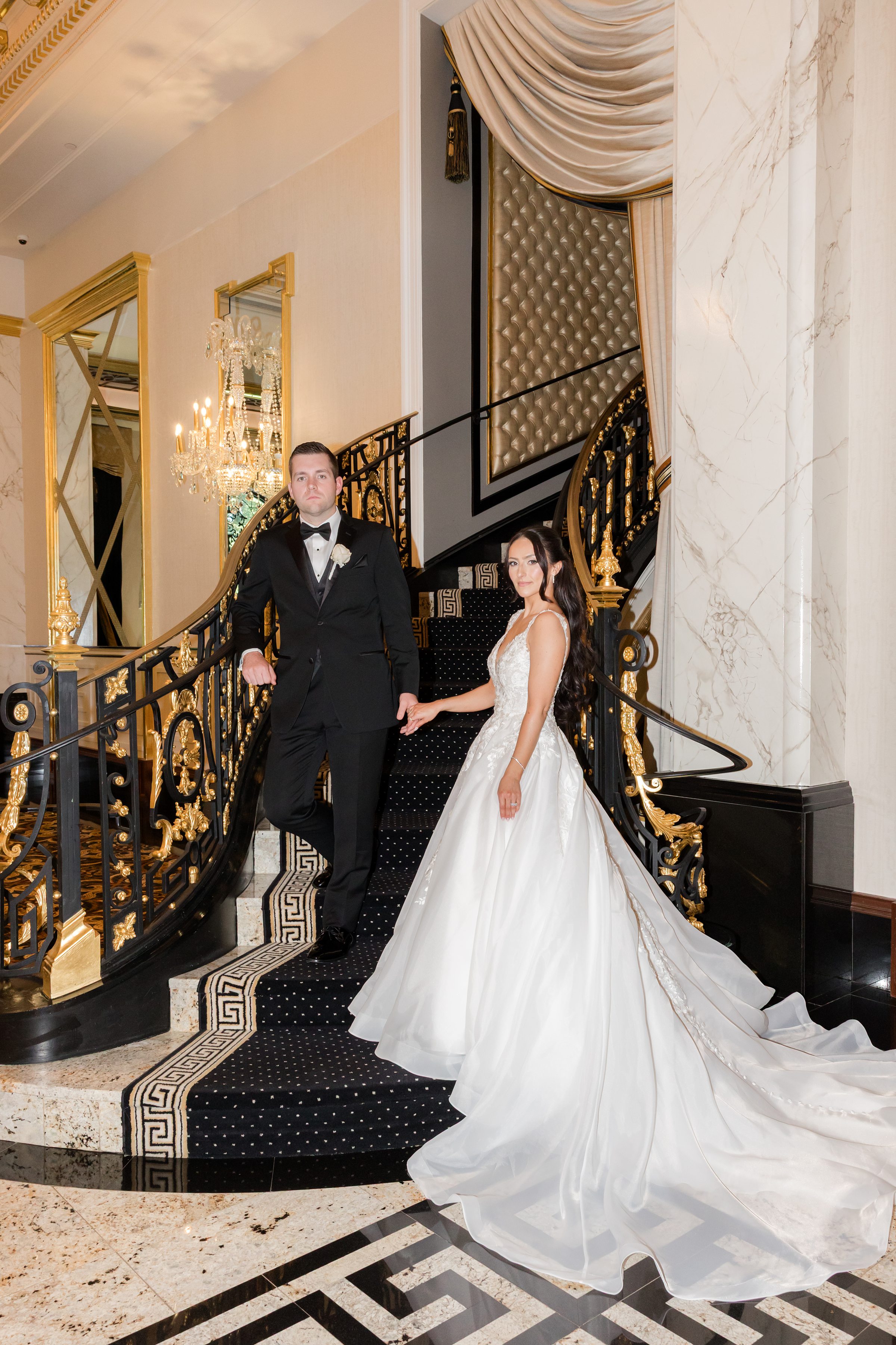Bride and groom holding hands together by the stairs