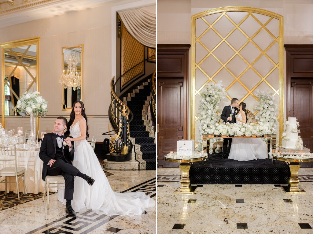 Groom is sitting on a chair while the bride is standing, smiling and kissing each other in the center beside the wedding cake 