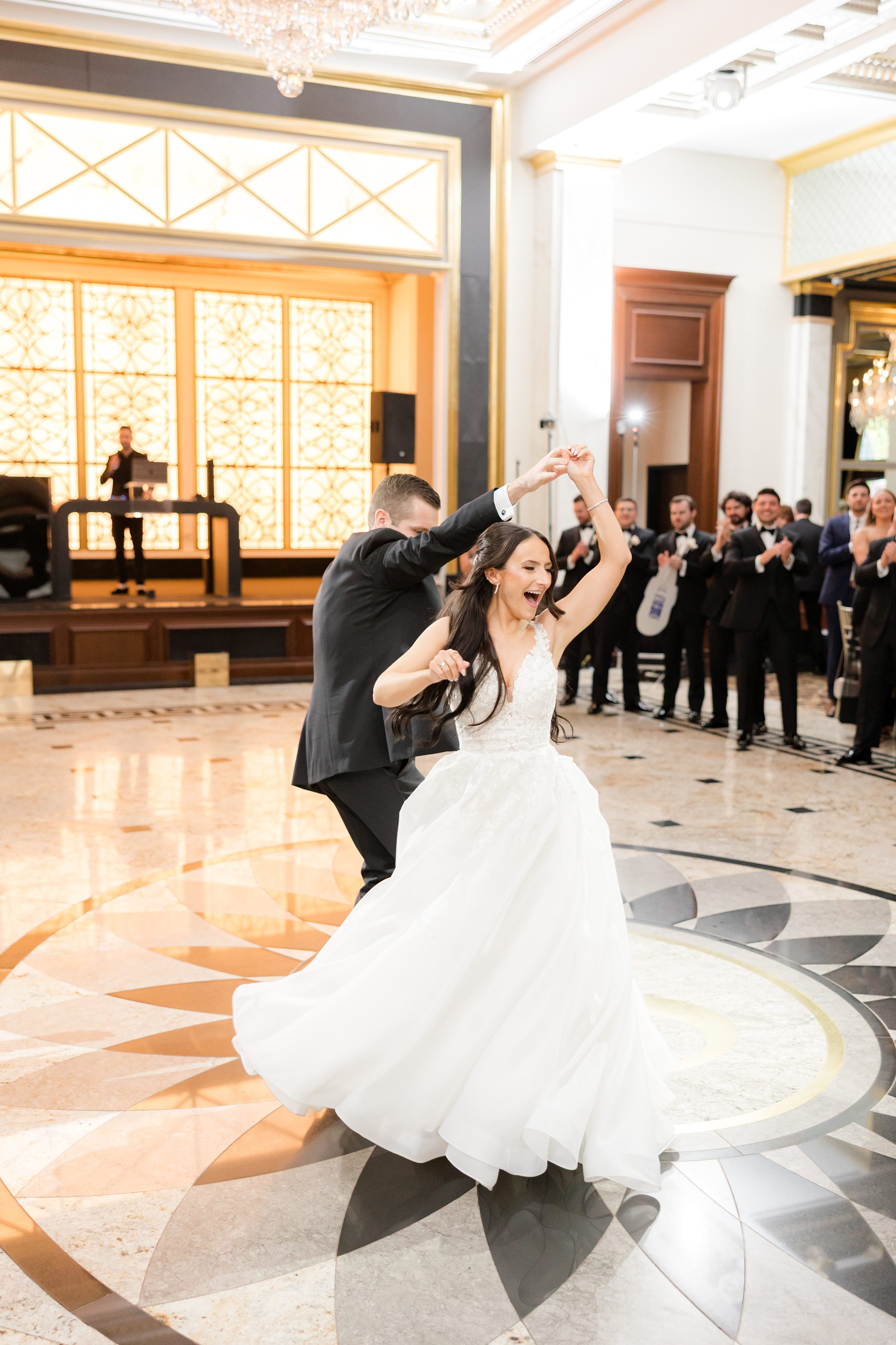 The couple are dancing together in front of the guests 