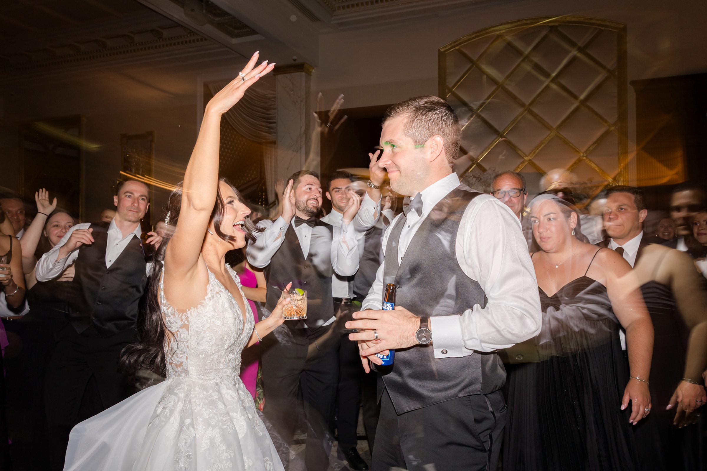 Groom removed his black coat, the couple are dancing together with the guests