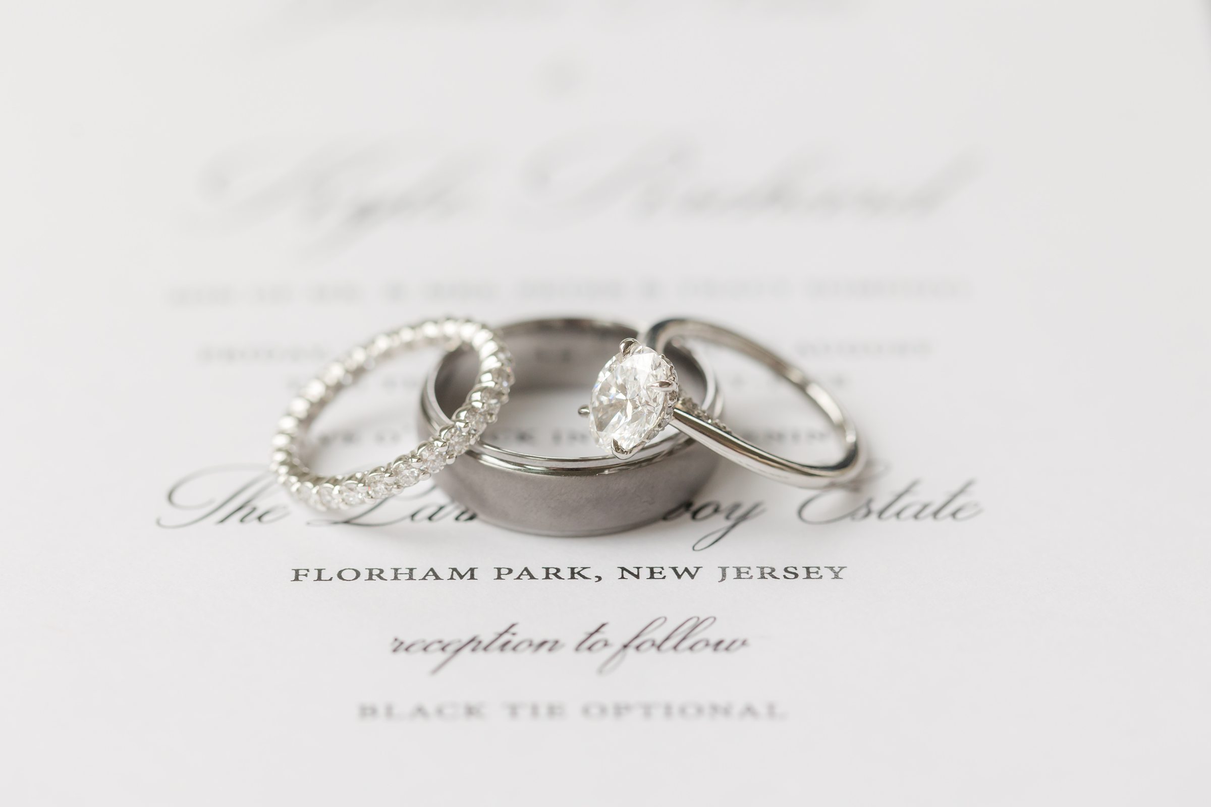 Detail shot of silver engagement ring and wedding bands