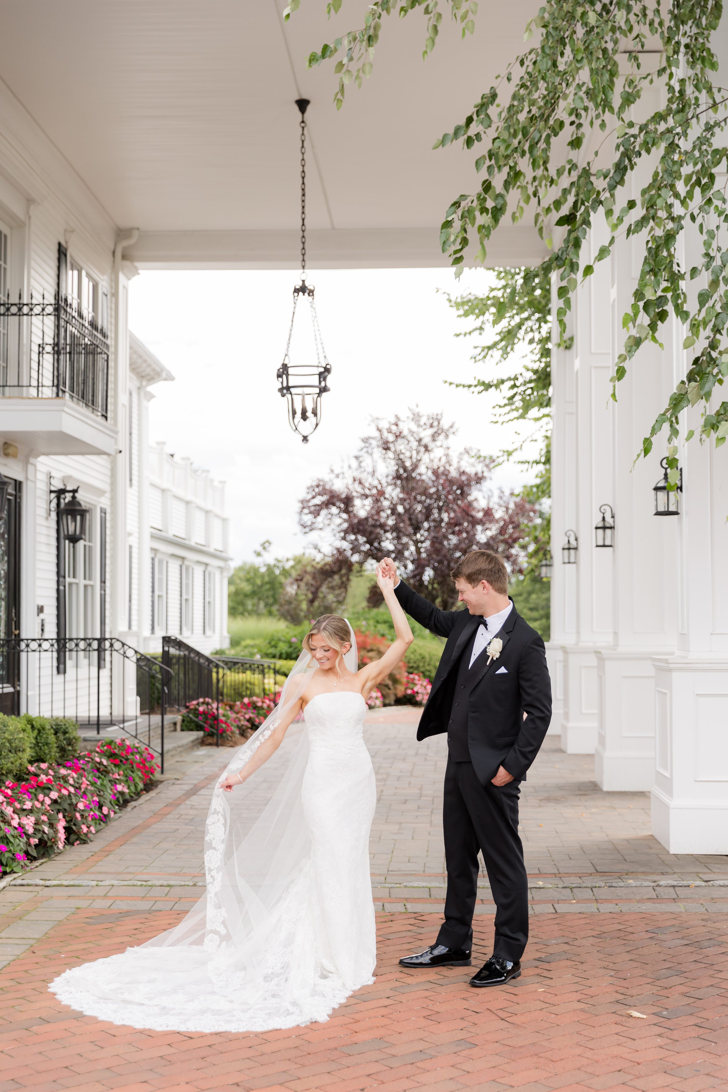 Groom holding the bride as she fixed her veil