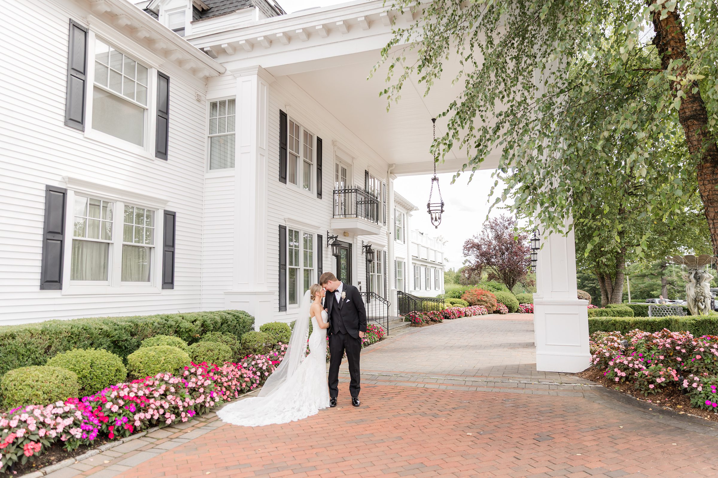 Photo of bride and groom bumping heads at Park Savoy's entrance