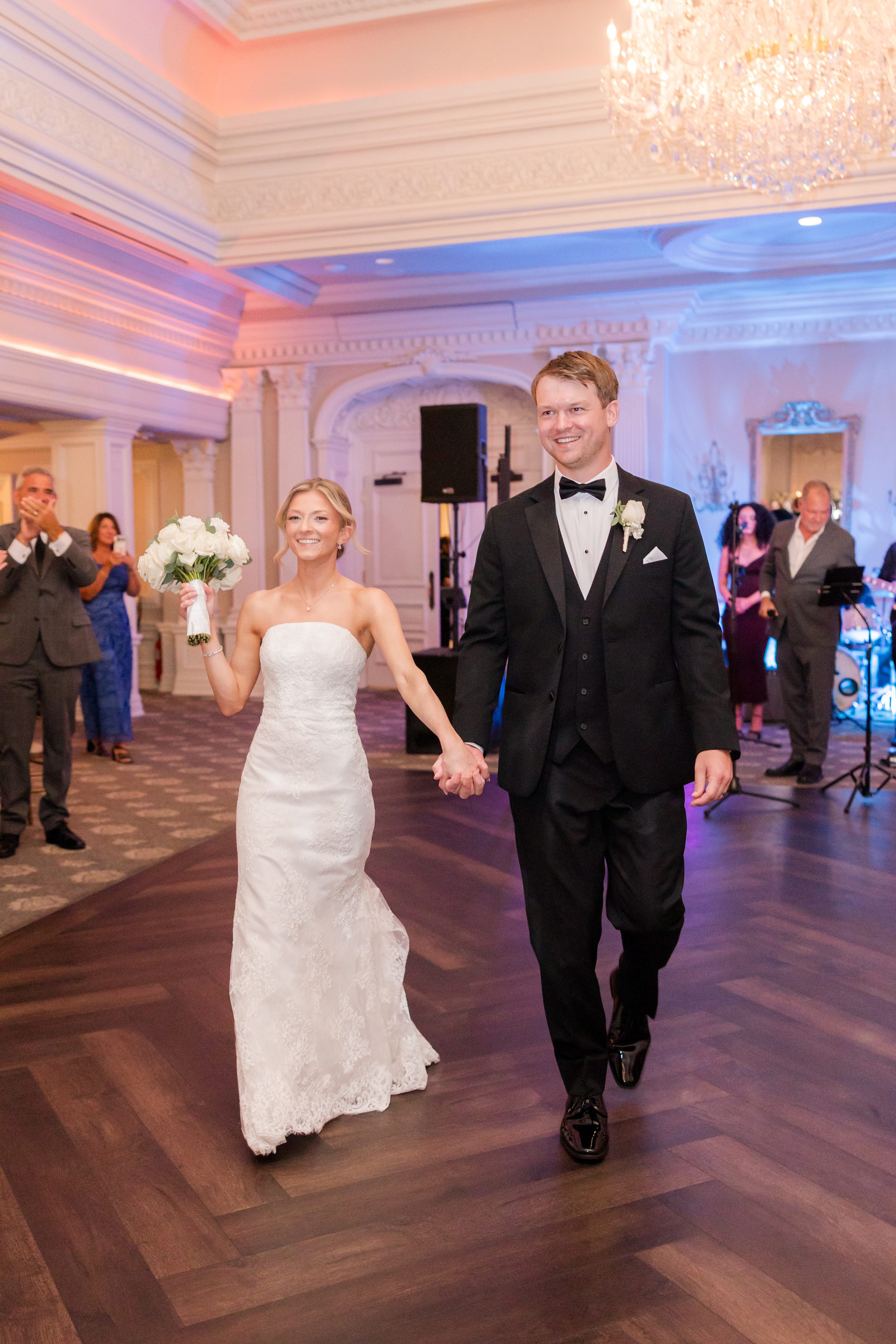 Bride and groom holding each other's hands during their grand entrance