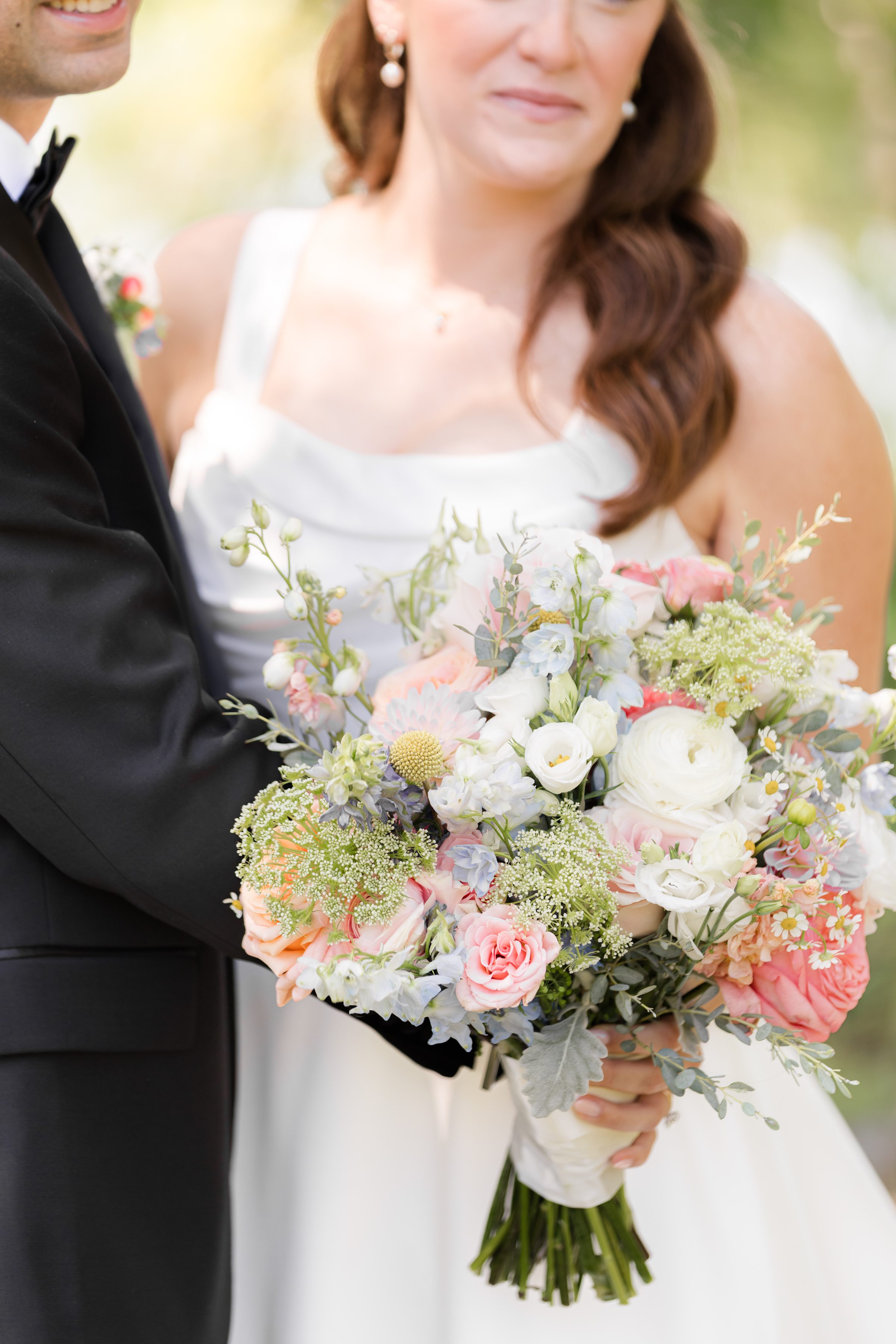 a detail shot of the flower bouquet, pink, orange, powder blue, green, white flowers
