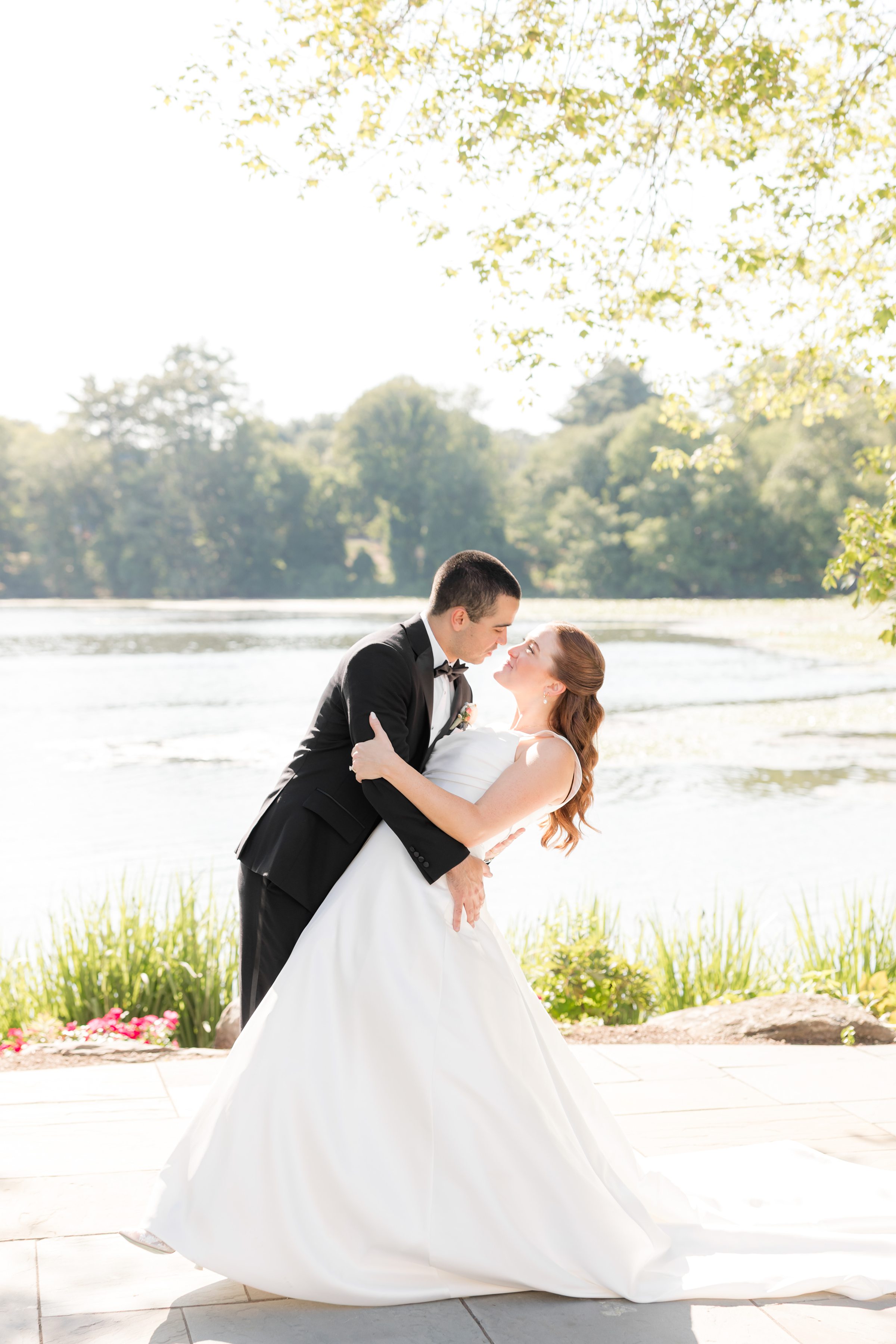 portrait picture of bride and groom going for a dip 