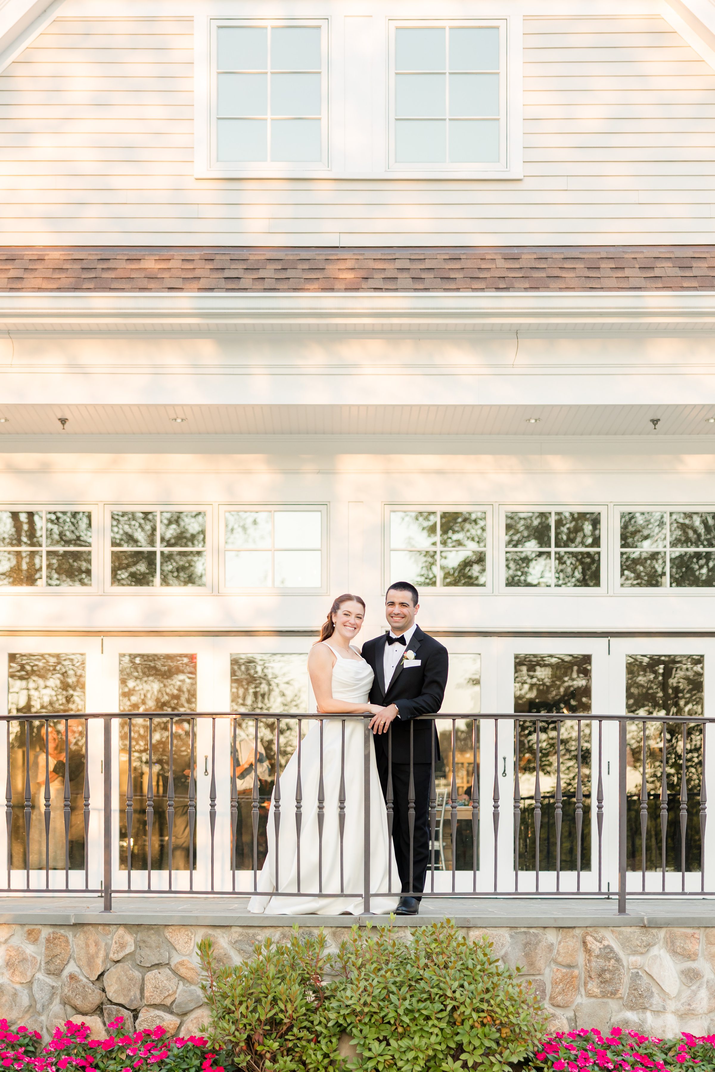 photo of groom and bride smiling at the camera, while being close to each other at Indian Trail Club