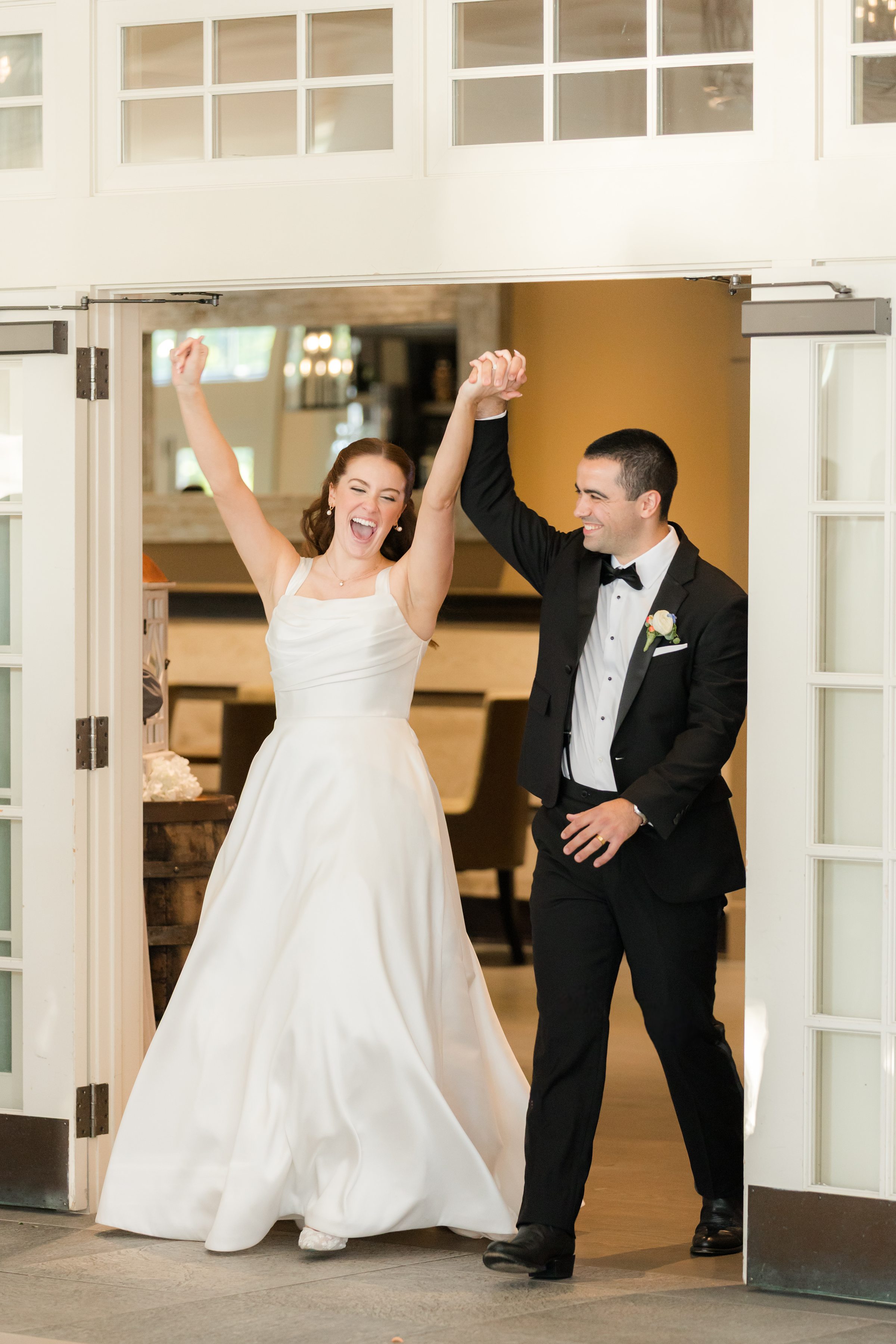 Bride and groom grand entrance with her hands held up high