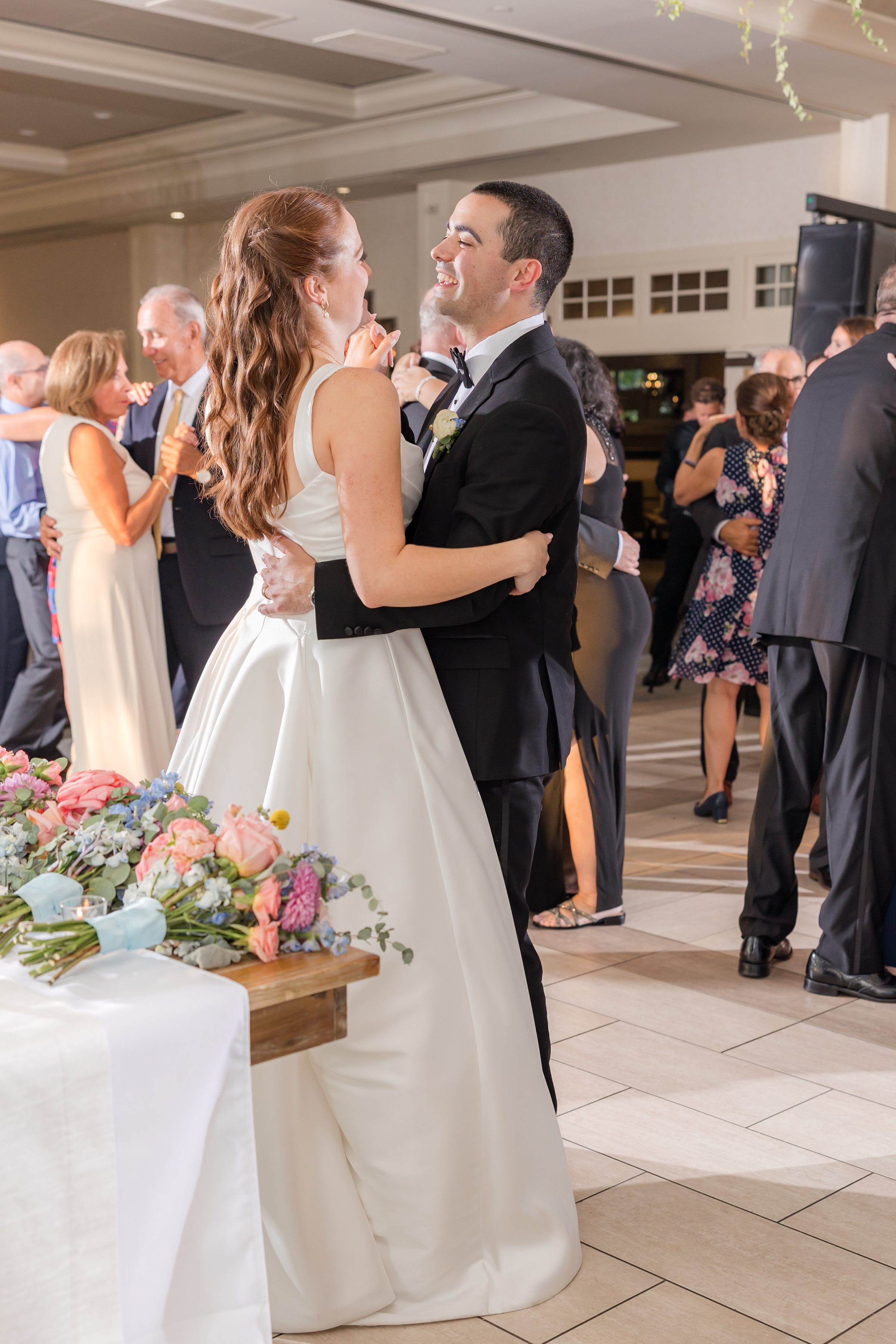 bride and groom dancing together with the guests