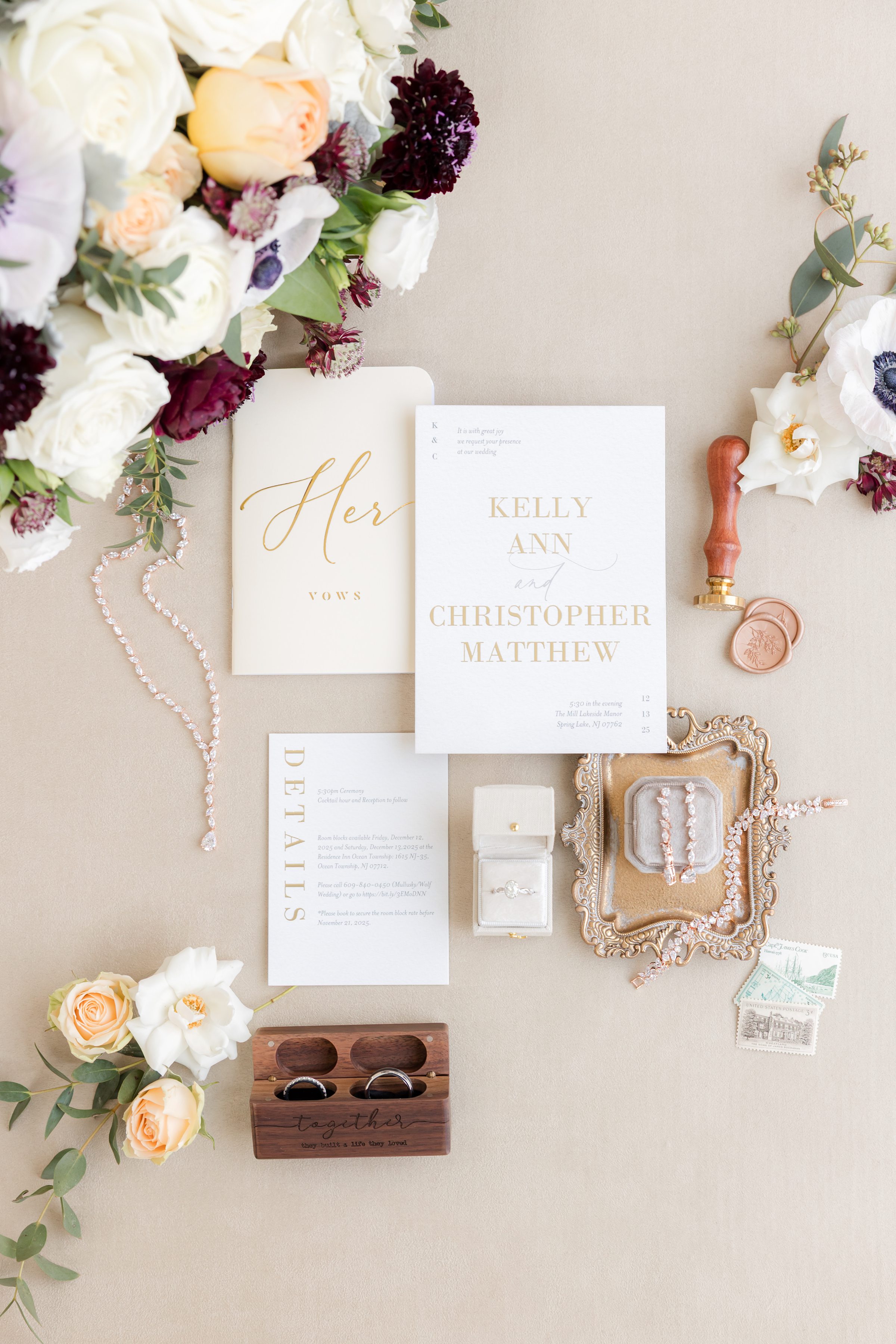 Wedding invitation suite with jewelry, florals, and wax seal details.