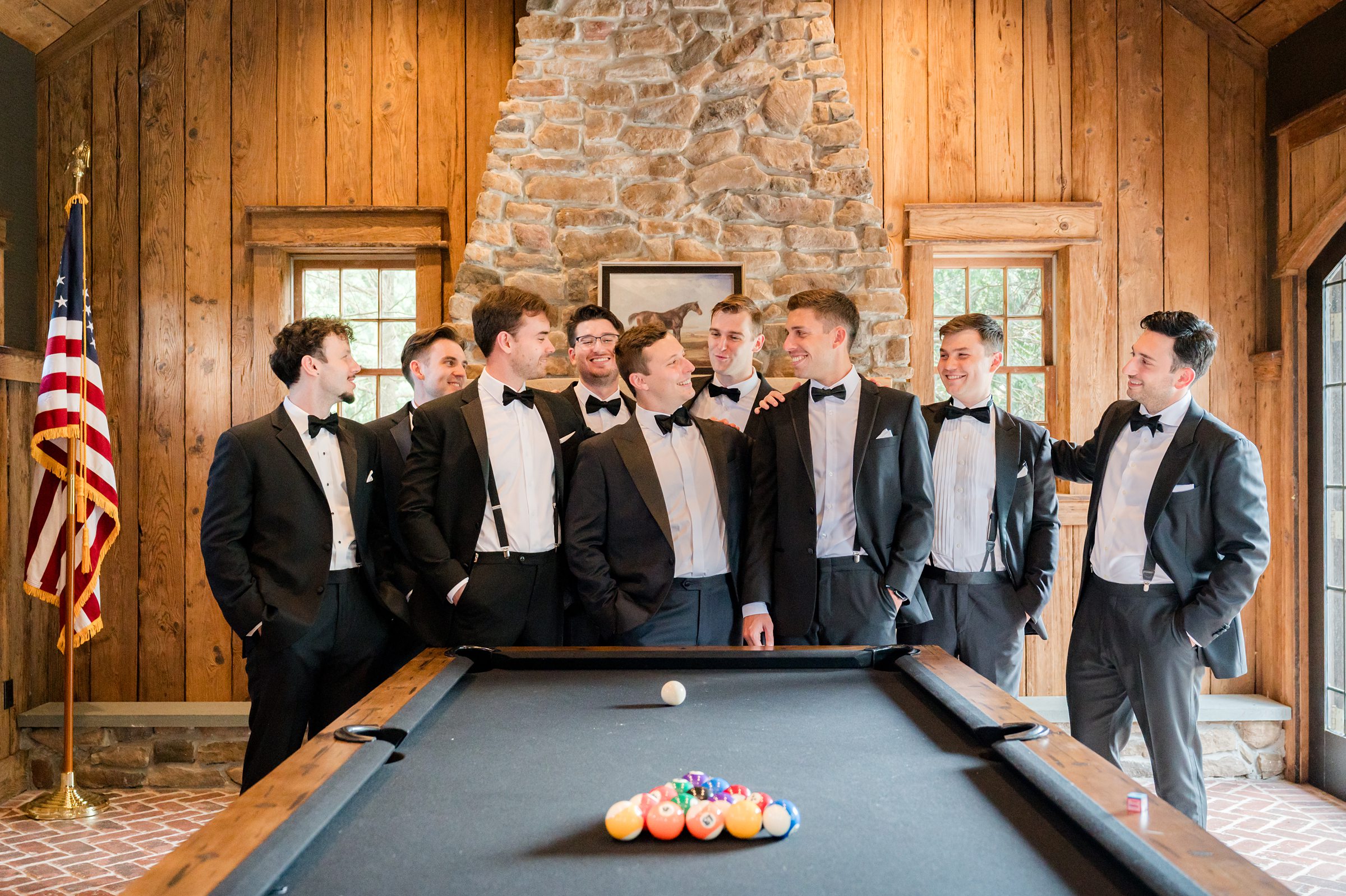 Groom and groomsmen bonding by the pool table