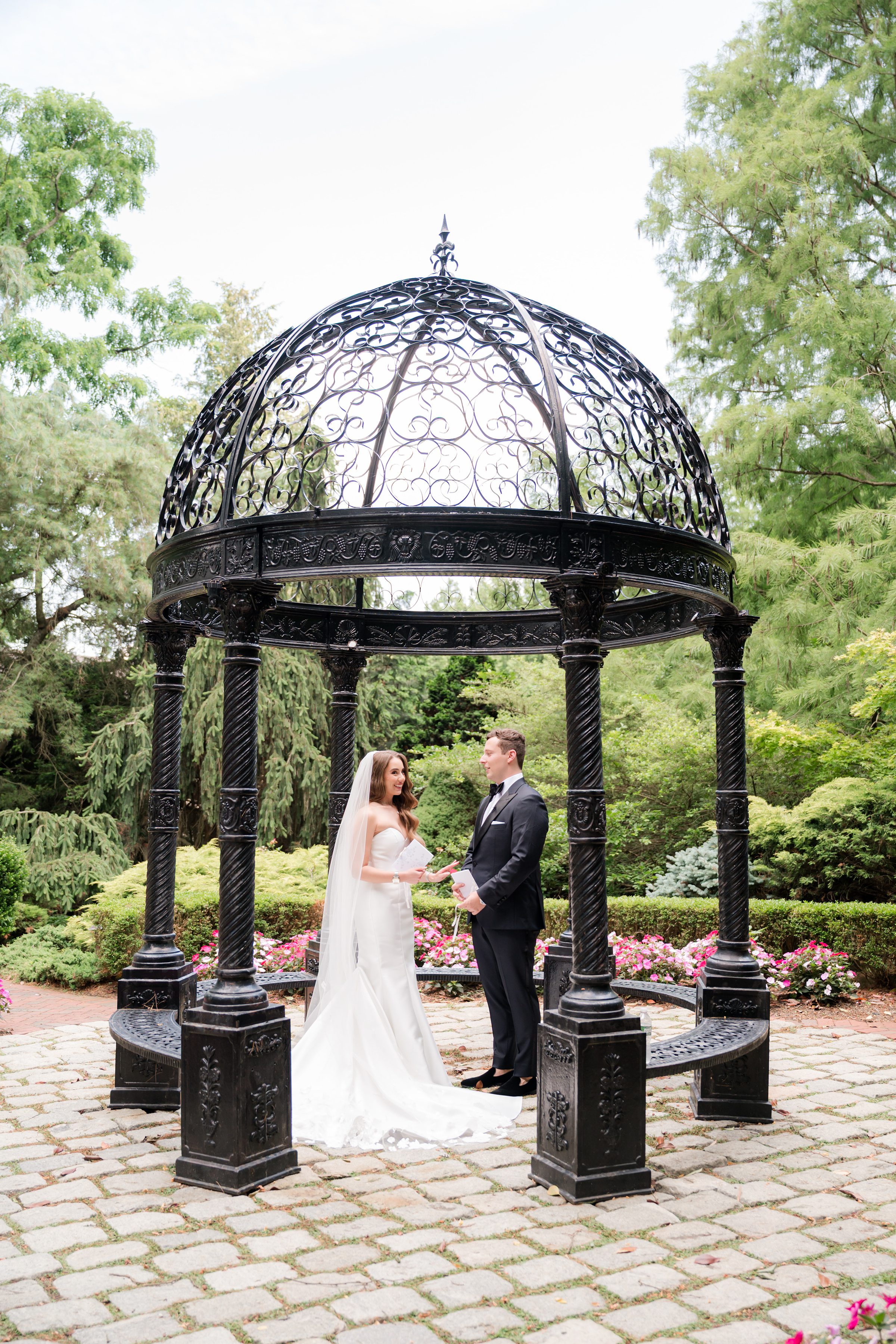 Bride and groom standing inside the gazebo holding their vows