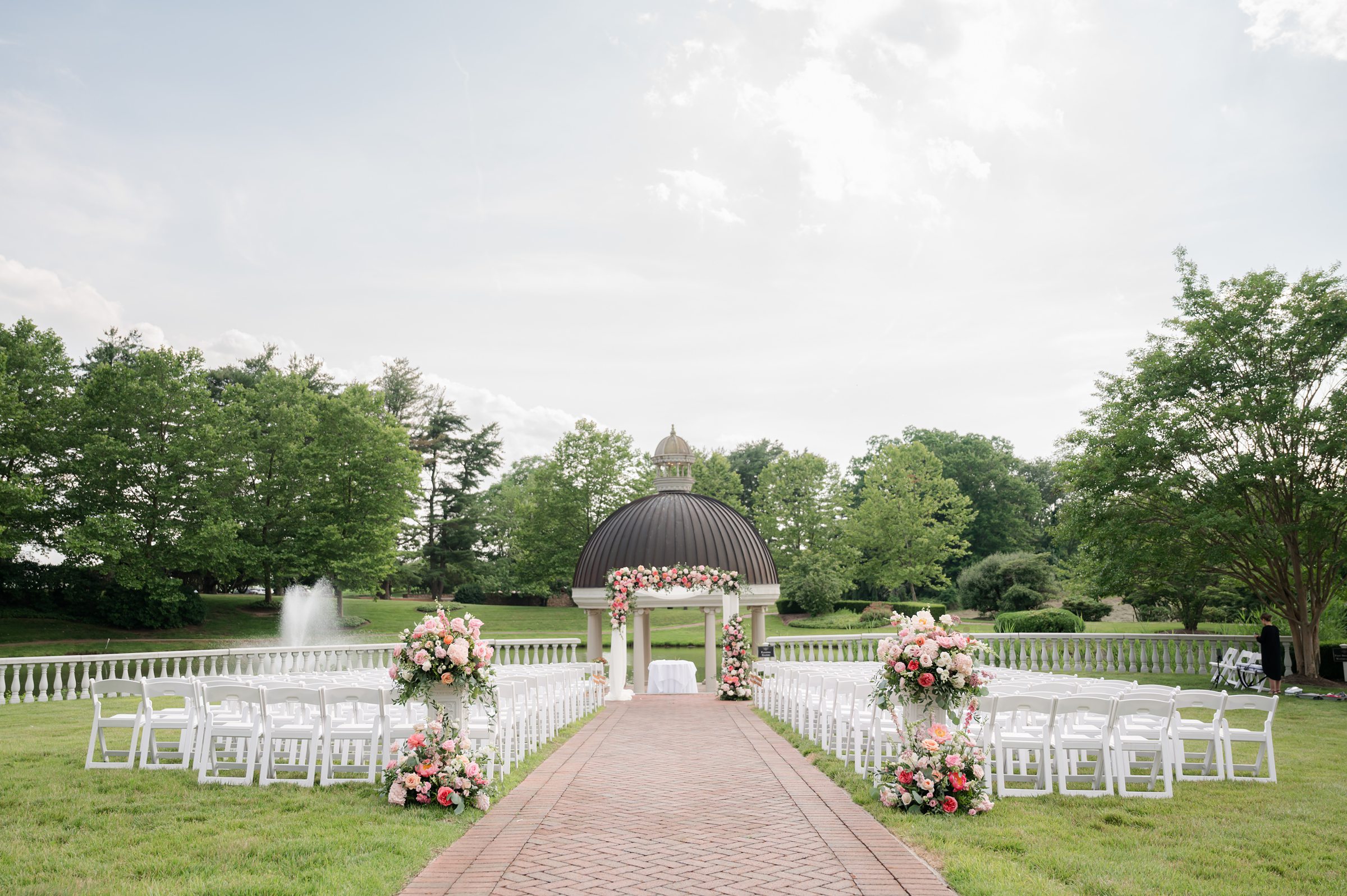 Garden ceremony landscape facing the gazebo with a fountain on the left and a big tree on the right
