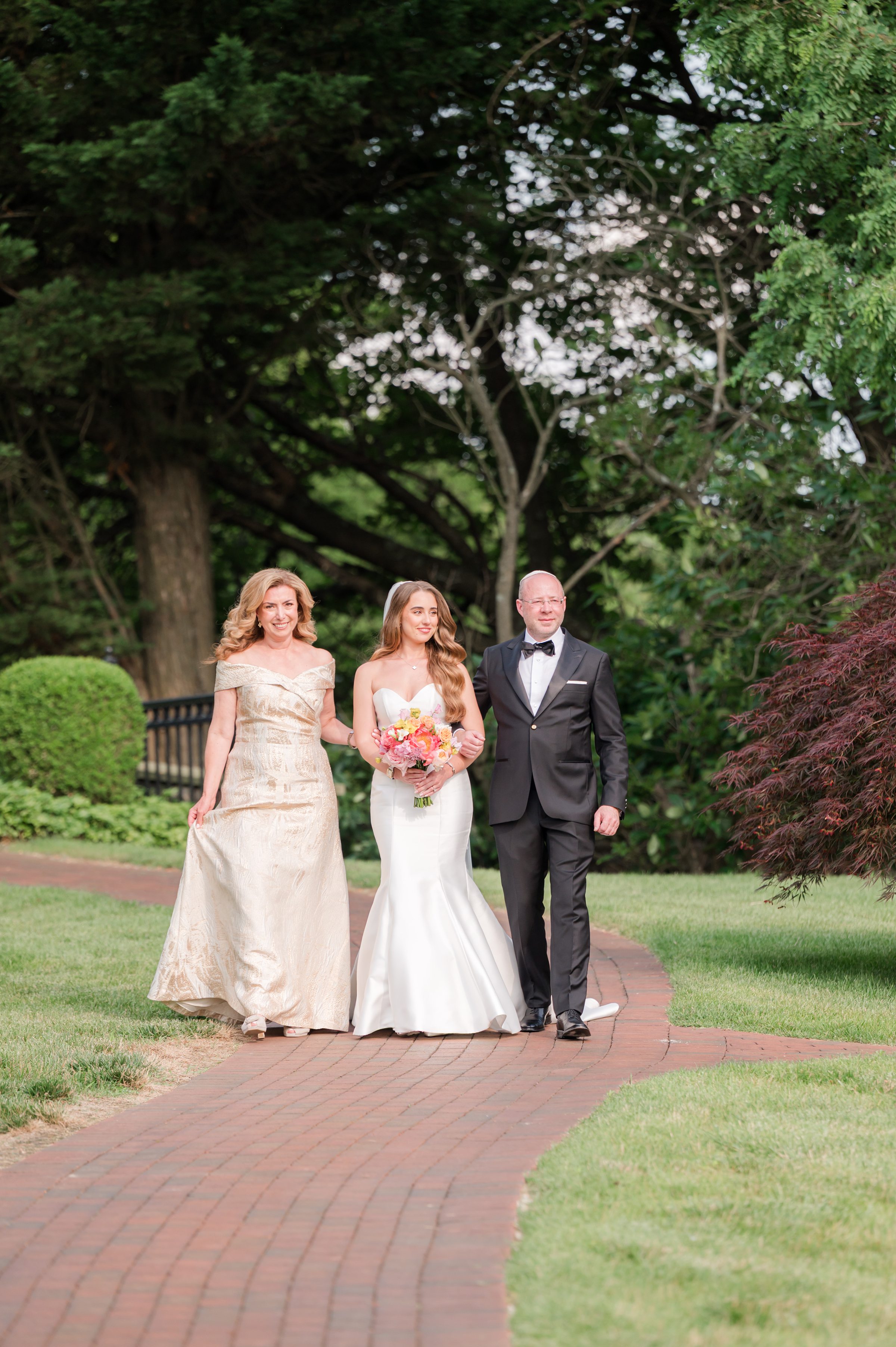 Parents of the bride walking the bride down the aisle