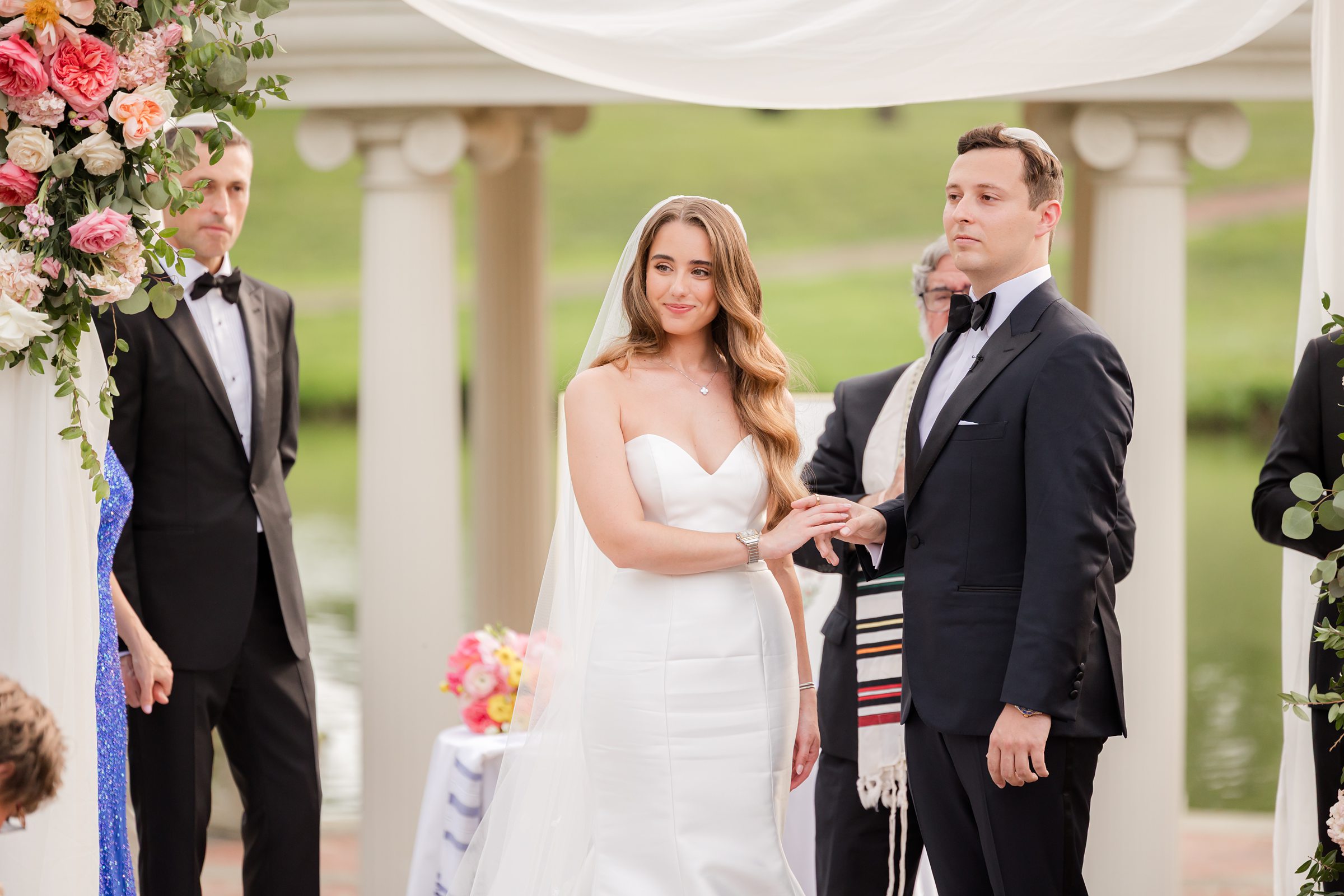 Bride and groom in the middle of the ceremony holding each others' hands