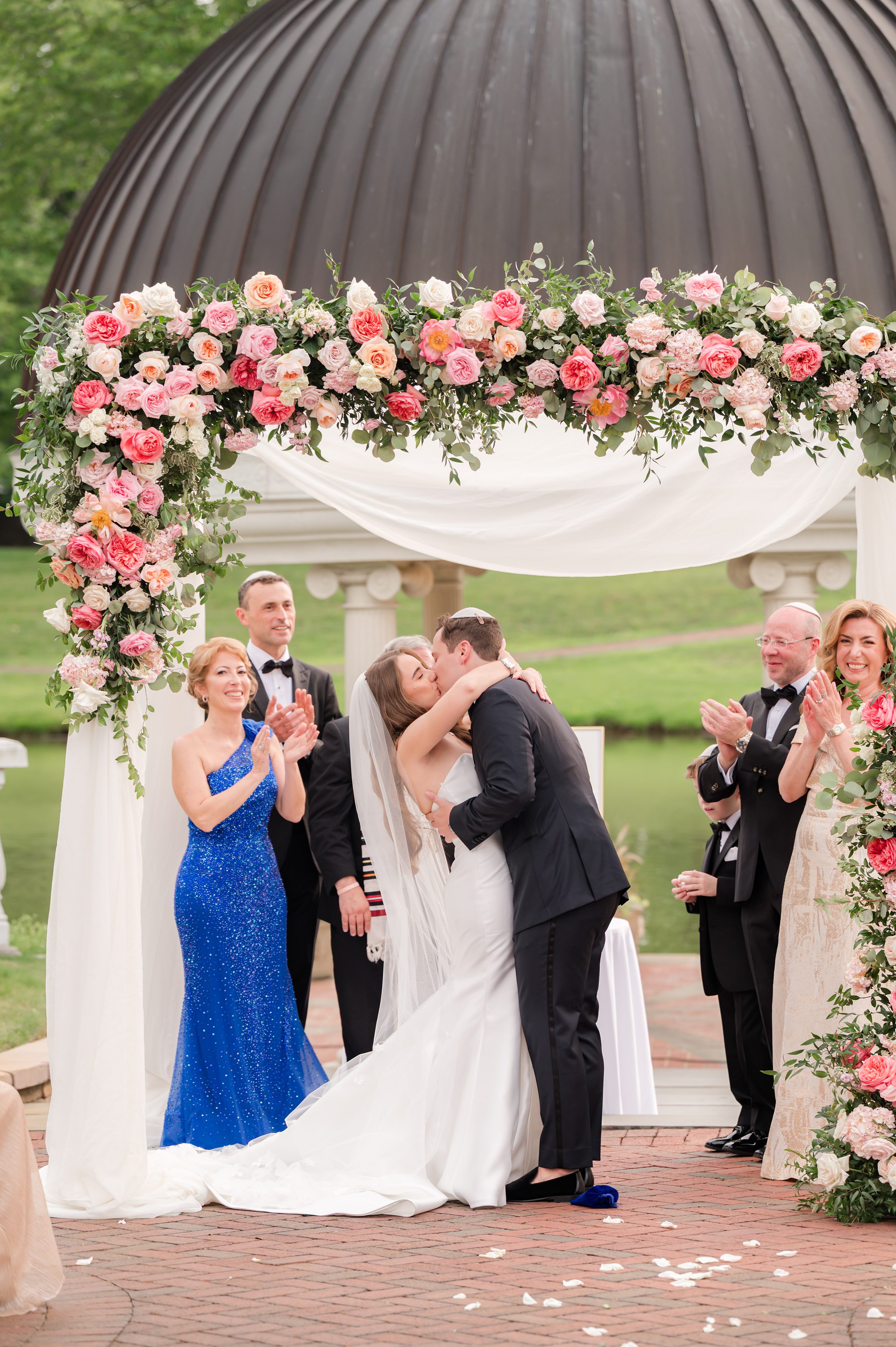 Bride and groom's first kiss as husband and wife under the chuppah