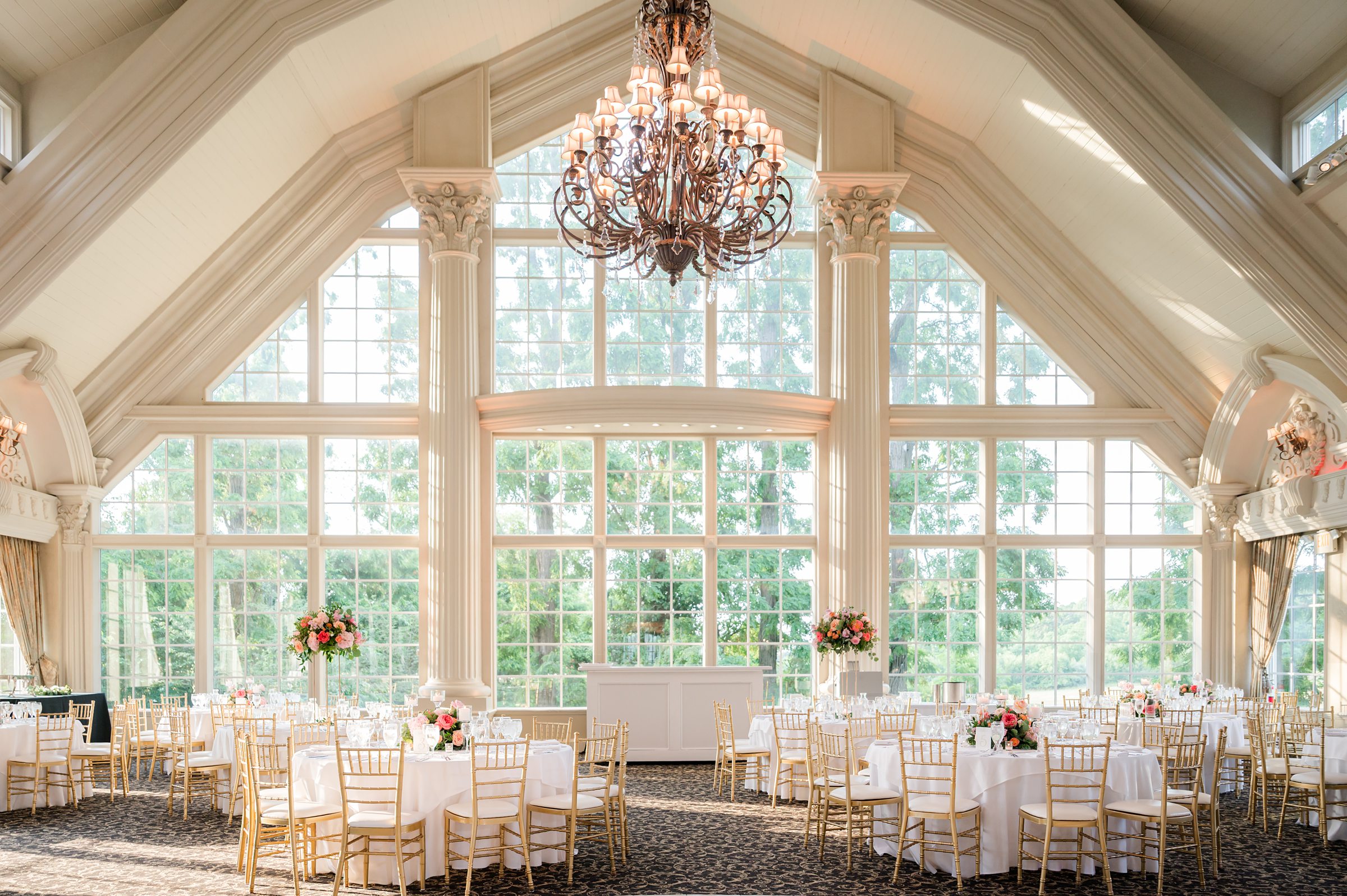 Reception hall with simple decorated tables, golden color chairs