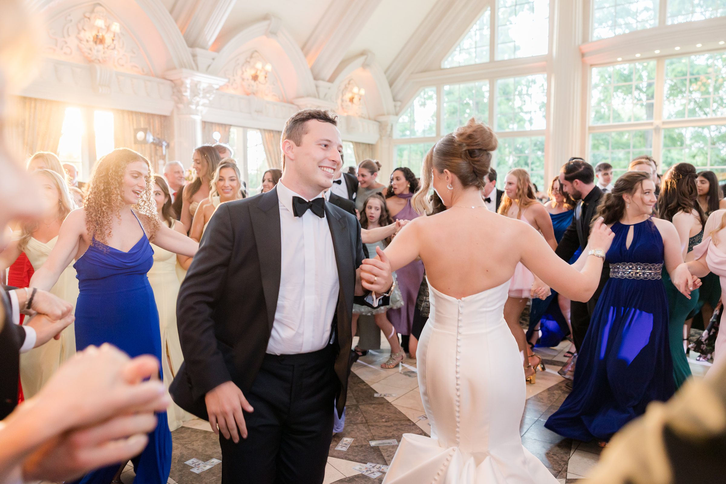 Bride and groom dancing together with the guests