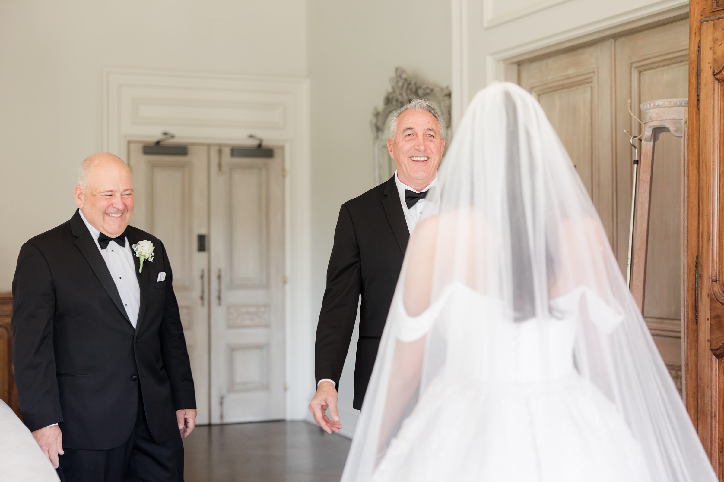 Step-dad and dad smiling at the bride