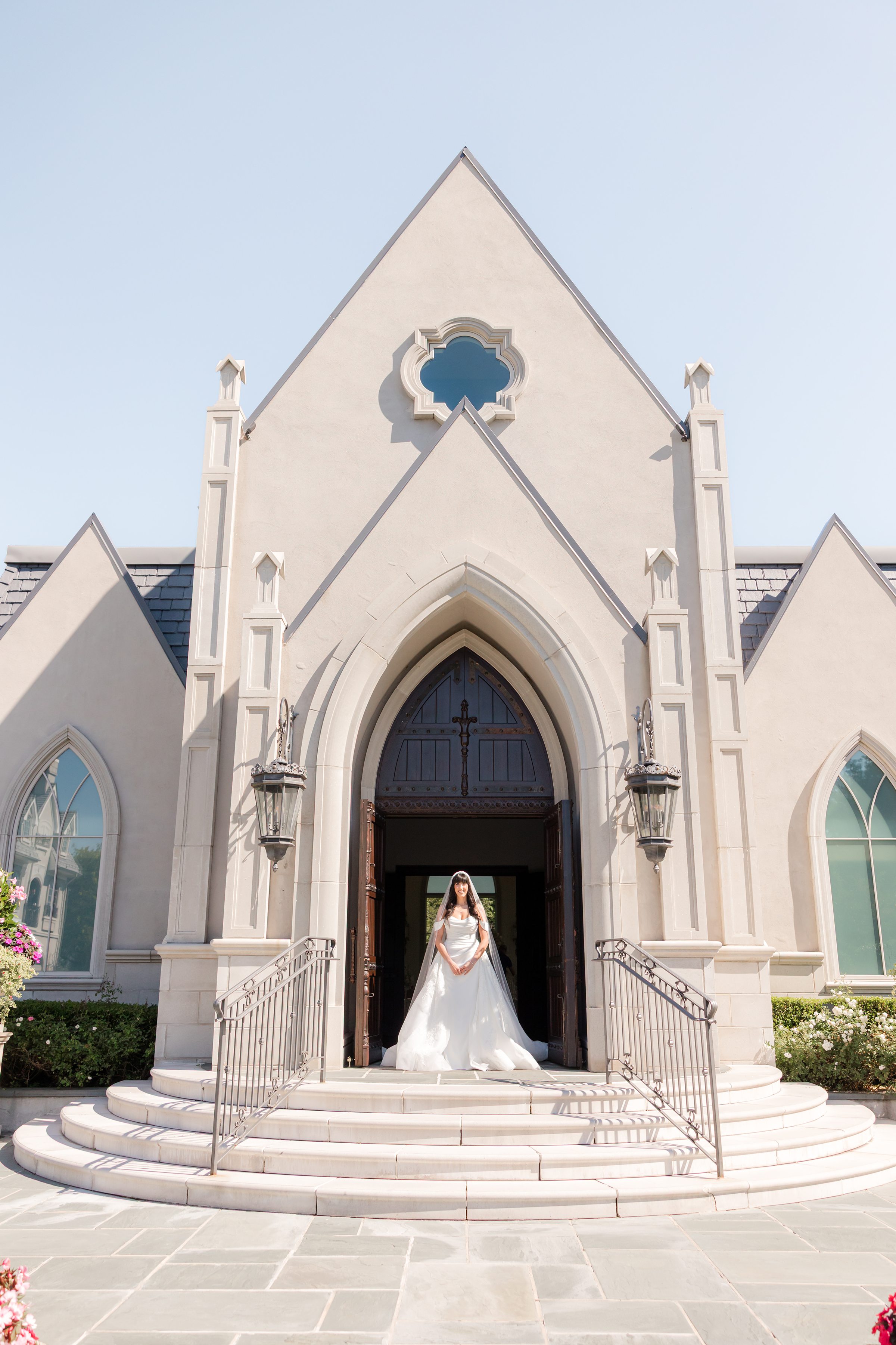 full portrait picture of bride standing at the entrance chapel 